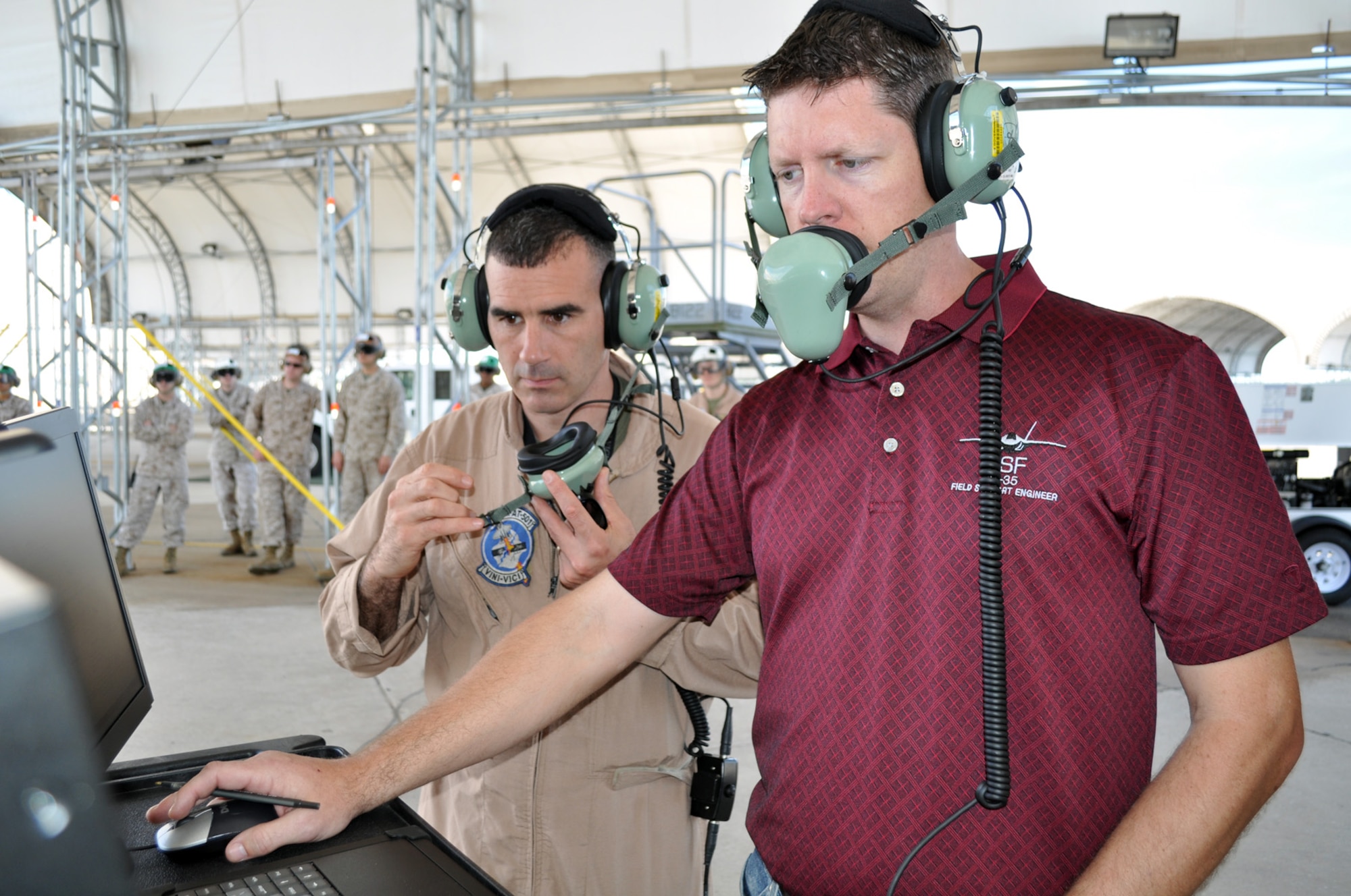 EGLIN AIR FORCE BASE, Fla. -- Marine Corps Maj. Aric Liberman, Marine Fighter Attack Squadron 501 operations officer at the 33rd Fighter Wing, Eglin AFB, Fla., uses the first engine run at Eglin of the F-35B as a training opportunity March 14. He observed the plane captain, known as a crew chief in the Air Force, speak to the pilot during actions to monitor the aircraft's health. Liberman will conduct an engine familiarization and subsequent aircraft taxi later this month. The F-35B is the Marine Corps variant of the Joint Strike Fighter. (U.S. Air Force photo/Maj. Karen Roganov)