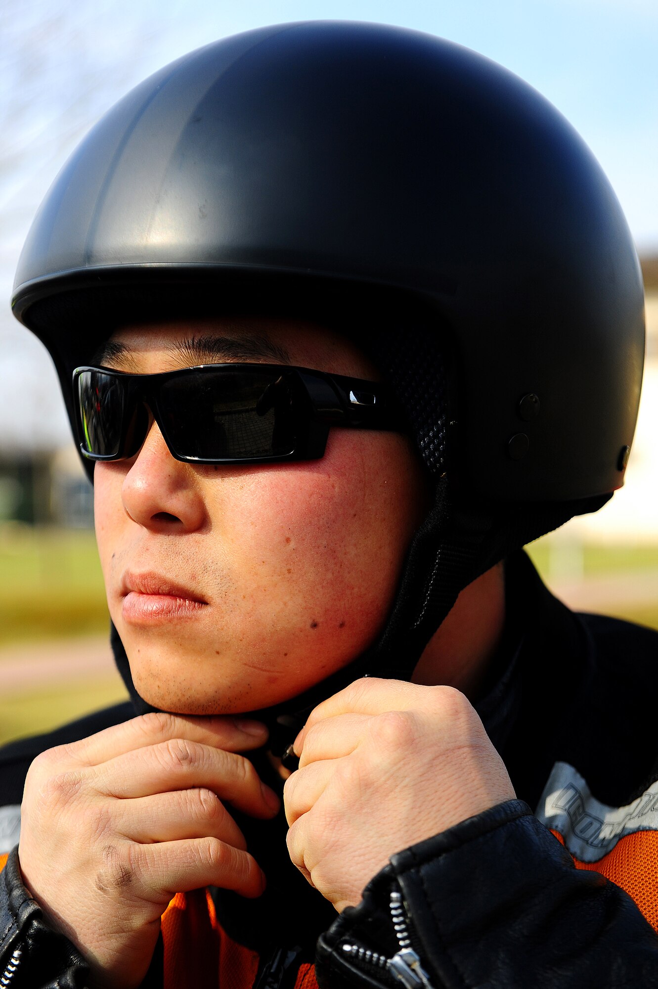 Air Force Master Sgt. Shannon Smith, 86th Aircraft Maintenance Squadron production superintendent, dons his helmet before a mentor ride during Motorcycle Safety Day, Ramstein Air Base, Germany, March 17, 2012. The safety day was held for the 86th Maintenance Group to promote safe motorcycle practices and raise camaraderie amongst the participants. (U.S. Air Force photo/Airman Brea Miller)