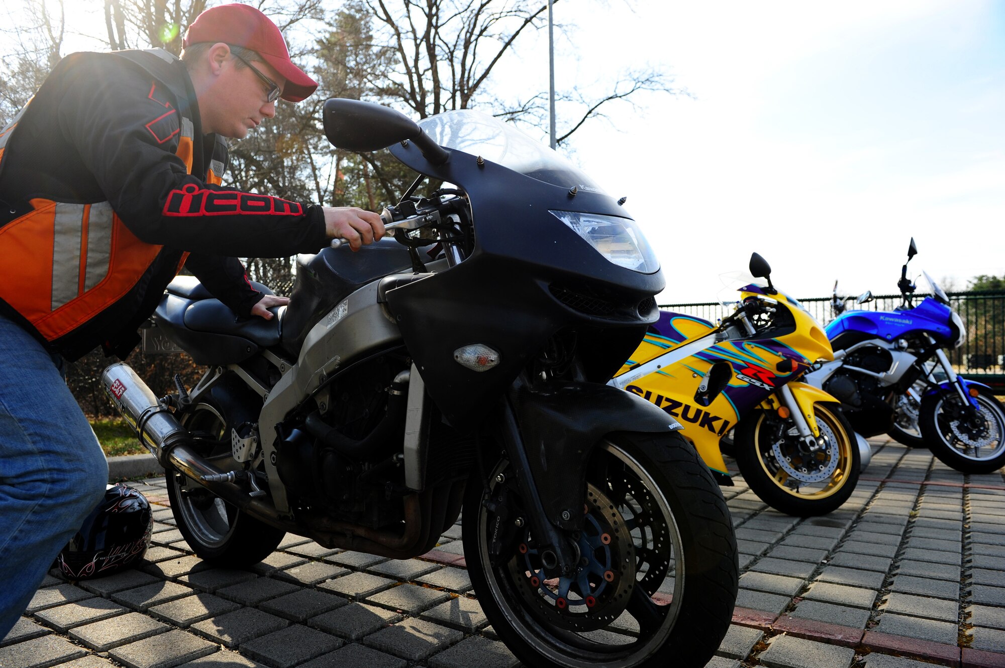 Senior Airmen Timothy Copple, 86th Aircraft Maintenance Squadron maintainer, inspects his motorcycle during Motorcycle Safety Day, Ramstein Air Base, Germany, March 17, 2012. The safety day was held for the 86th Maintenance Group to promote safe motorcycle practices and raise camaraderie amongst the participants. (U.S. Air Force photo/Airman Brea Miller)