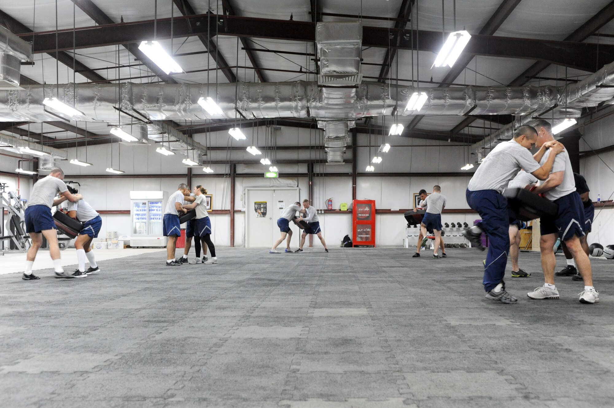 SOUTHWEST ASIA -- Airmen from the 332nd Air Expeditionary Wing perform knee strikes during a Krav Maga class at an undisclosed location in Southwest Asia, March 14, 2012. The seven-day course trained Airmen on the martial arts discipline, which they can use to defend themselves during hostile encounters. The training focuses on Combined Forces Air Component Commander’s priority of defending the base. (U.S. Air Force Photo by Staff Sgt. Joshua J. Garcia)