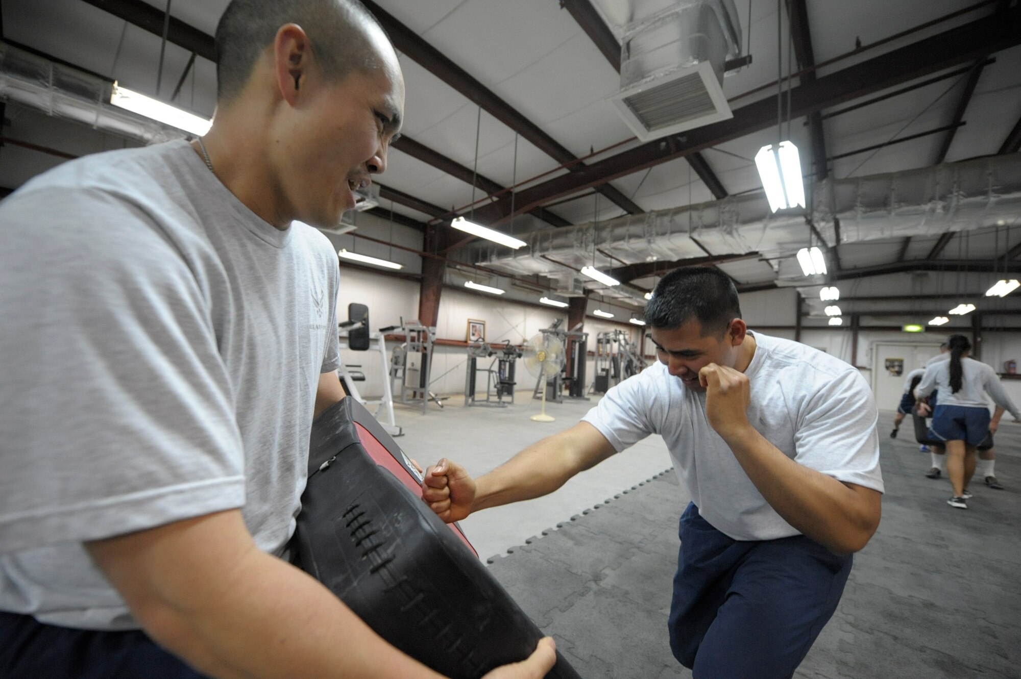 SOUTHWEST ASIA -- Senior Airman Sheung Wong and Staff Sgt. Patrick Aurello, 332nd Expeditionary Communication Squadron members, perform downward hammer fists during a Krav Maga class at an undisclosed location in Southwest Asia, March 12, 2012. Krav Maga is a martial arts discipline which was first introduced in the 1950s and came to the United States in the 1980s. Wong and Aurello are deployed with the Hawaii Air National Guard and are natives of Hawaii. (U.S. Air Force Photo by Staff Sgt. Joshua J. Garcia)