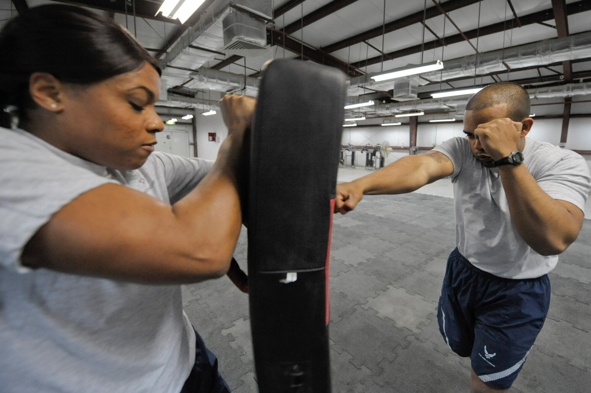 SOUTHWEST ASIA -- Staff Sgt. Brittany Torrence, 332nd Air Expeditionary Wing member, and Airman 1st Class Rick Palomares, 332nd Expeditionary Security Forces Squadron member, perform jabs during a Krav Maga class at an undisclosed location in Southwest Asia, March 12, 2012. During the seven-day class, Torrence and Palomares trained on self-defense maneuvers and striking techniques. Torrence is deployed from Kadena Air Base, Japan, and is a native of Reserve, La. Palomares is deployed from Mountain Home Air Force Base, Idaho.   (U.S. Air Force Photo by Staff Sgt. Joshua J. Garcia)