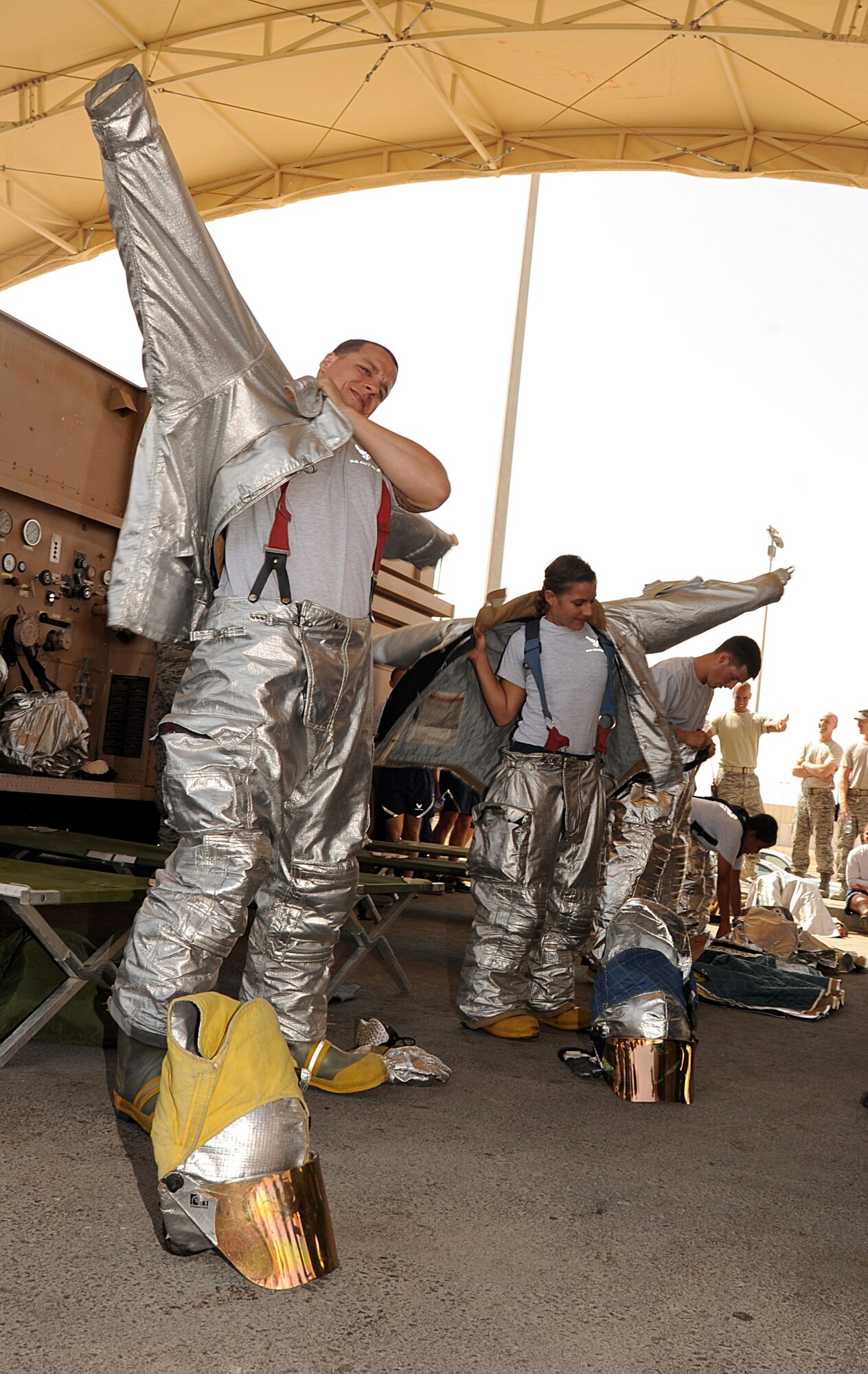 SOUTHWEST ASIA - Airmen from the 380th Air Expeditionary Wing compete in a fire muster March 17, 2012.  During the fire muster, each four-person team had to accomplish five challenges based on skills firefighters hone every day. Out of the seven teams the team from the 380th Expeditionary Civil Engineer Squadron programs flight was declared the winner. (U.S. Air Force photo/Tech. Sgt. Arian Nead)  
  
