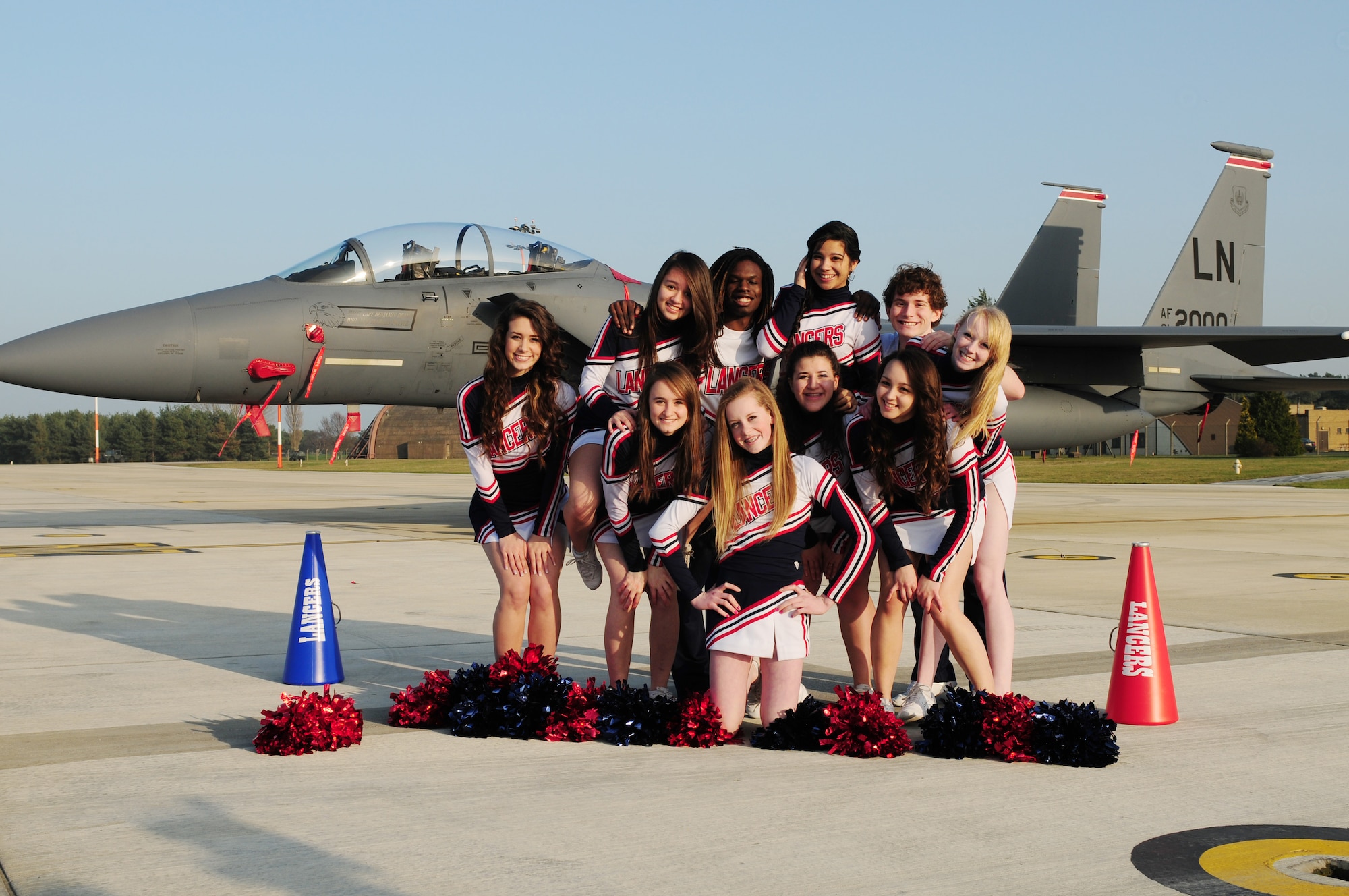 ROYAL AIR FORCE LAKENHEATH, England -- Lakenheath High School cheerleaders pose for a photo on the flightline March 15, 2012. (From left, top row) Alexa Gorham, Kimberly Cowderoy, Treyvon Bradsher, Alysha Brooks, Mackenzie Hall, Susanna Renfrow (captain), (from left, bottom row), Erin Butler, Ashley Catallanos, Rebecca Rodriguez and Darian Crowley (captain). The LHS cheerleaders won first place during the 2012 Department of Defense Dependent Schools Division 1 European Championships in Wiesbaden, Germany, Feb. 25, 2012. In addition to their first place win, they also brought home the Spirit Award, which is given to the school with the most spirit, and four individual All Tournament Cheerleader awards.  (U.S. Air Force photo by Senior Airman Lausanne Morgan)