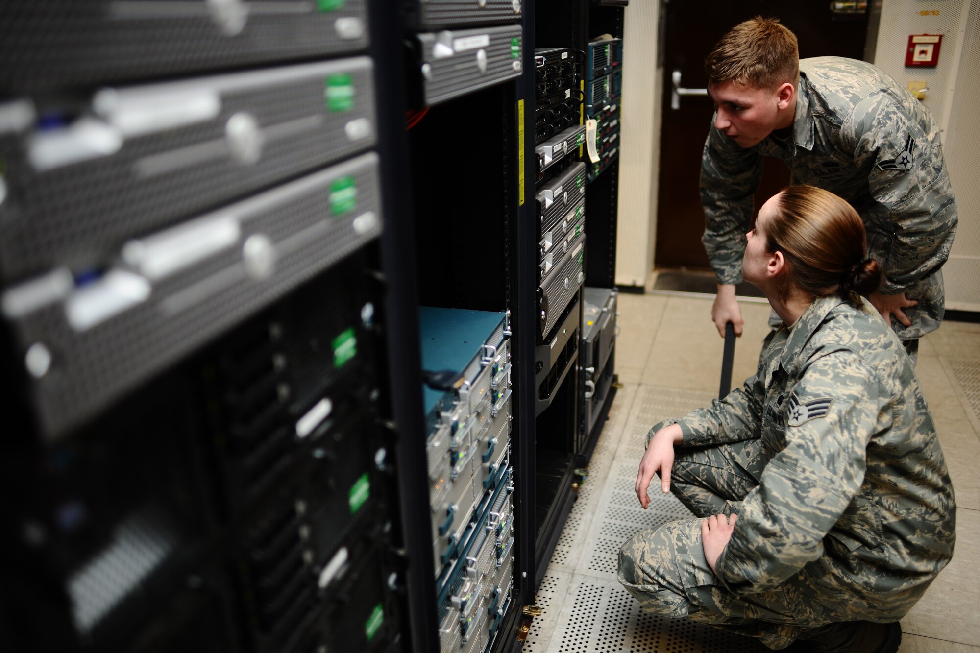 SPANGDAHLEM AIR BASE, Germany – Airman 1st Class Craig Evans and Senior Airman Colleen Farver, 52nd Communications Squadron cyber operations journeymen, inspect an error code being displayed at the network control center here March 15. The 52nd CS Systems Communications Operations Flight Cyber Operations Section develops and maintains foundational communication capabilities for the 52nd Fighter Wing by providing network services including messaging, share drives, and network access and storage to the base and its geographically-separated units. (U.S. Air Force photo by Airman 1st Class Matthew B. Fredericks/Released)