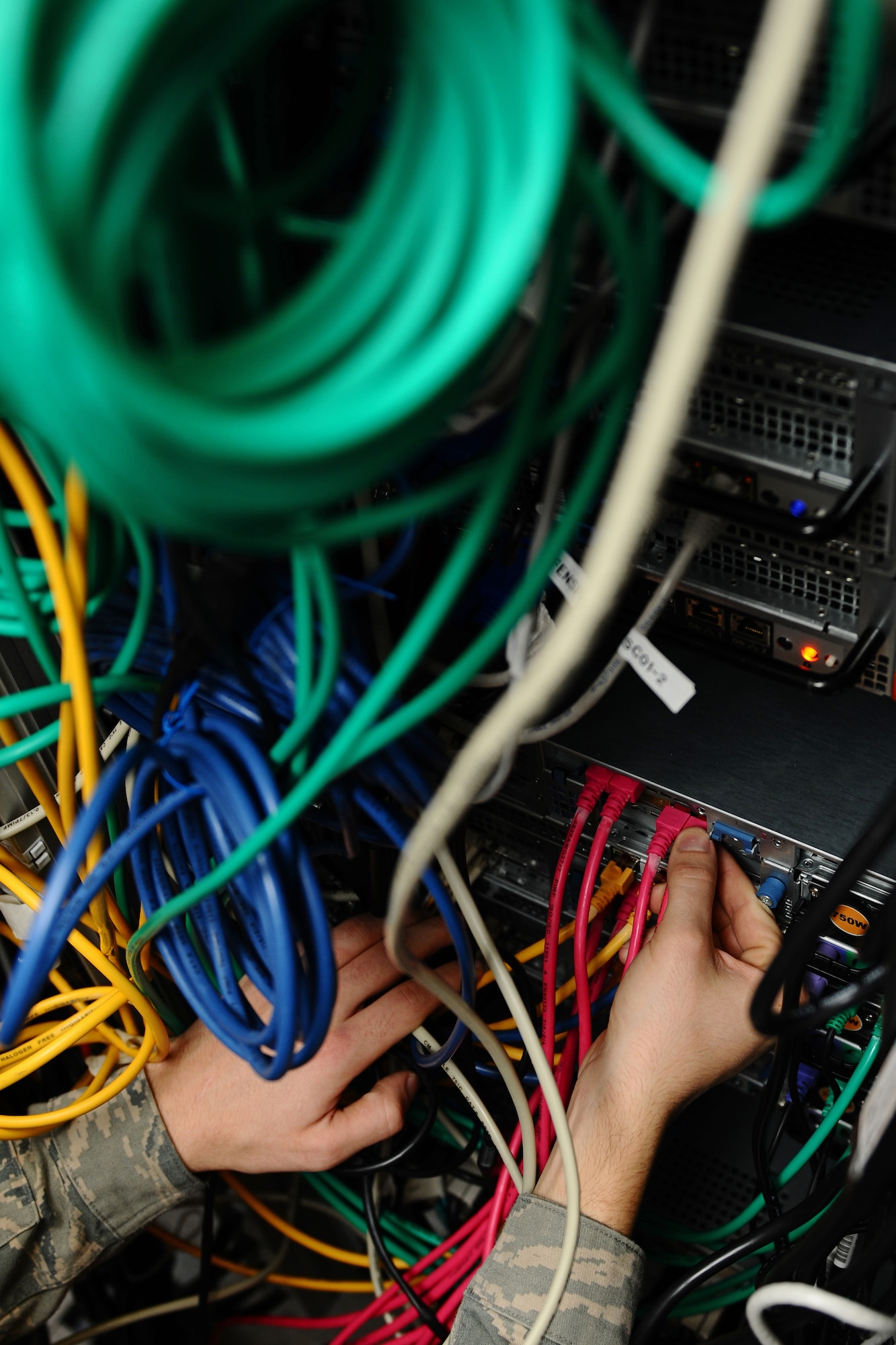 SPANGDAHLEM AIR BASE, Germany – A 52nd Communications Squadron cyber systems operator reconnects a server while conducting a maintenance check at the network control center here March 15. The 52nd CS Systems Communications Operations Flight Cyber Operations Section develops and maintains foundational communication capabilities for the 52nd Fighter Wing by providing network services including messaging, share drives, and network access and storage to the base and its geographically-separated units. (U.S. Air Force photo by Airman 1st Class Matthew B. Fredericks/Released)