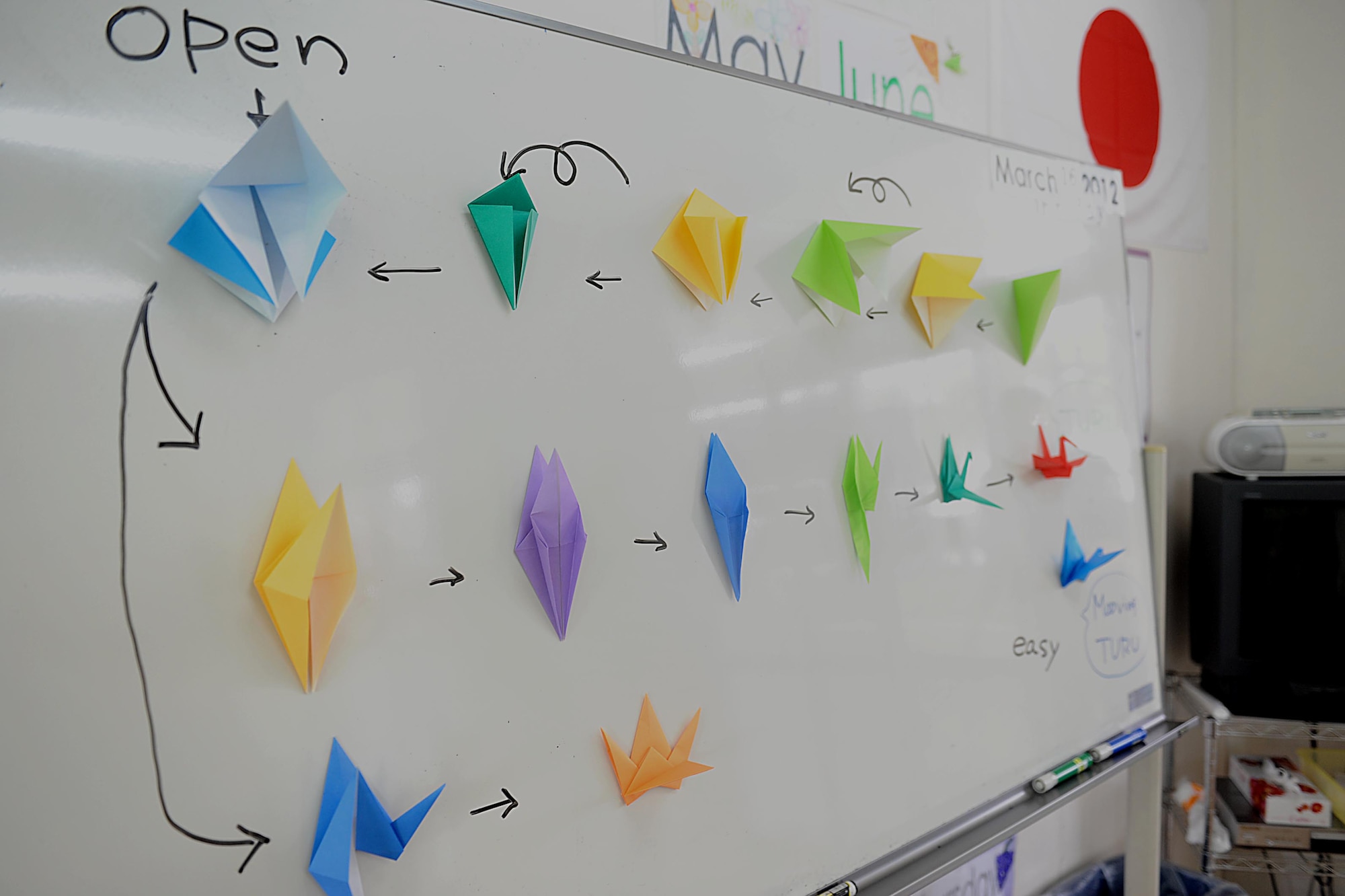 A classroom board displays instructions on how to make a paper crane during Chatan Town's Busy Bee School's friendship day on Okinawa, March 17, 2012. The school invited service members to spend the day with them to show their appreciation for help during Operation Tomodachi. (U.S. Air Force photo by Airman 1st Class Brooke P. Beers/Released)