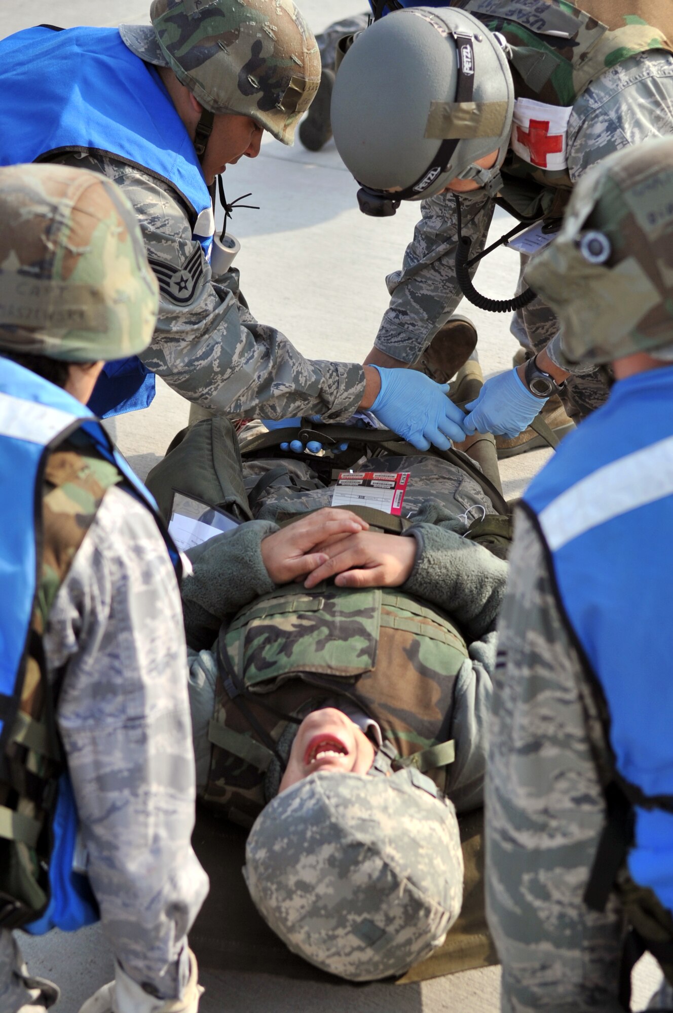 Airmen from the 51st Aerospace Medicine Squadron secure a patient onto a litter during operational readiness exercise Beverly Midnight 12-01, March 19, 2012. The exercise scenarios test Team Osan’s ability to defend the base and conduct daily operations in a heightened state of readiness. (U.S. Air Force photo/Staff Sgt. Craig R. Cisek)