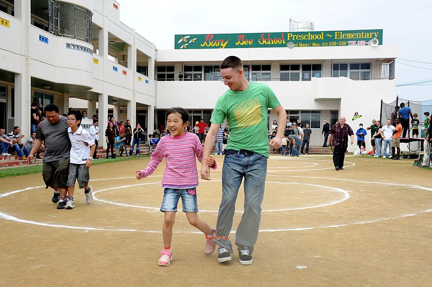 U.S. Air Force Airman 1st Class Trent Lloyd, 18th Security Forces Squadron, participates in a three-legged race at Chatan Town's Busy Bee School during a friendship day on Okinawa, March 17, 2012. The school invited service members to spend the day with them to show their appreciation for help during Operation Tomodachi. (U.S. Air Force photo by Airman 1st Class Brooke P. Beers/Released)