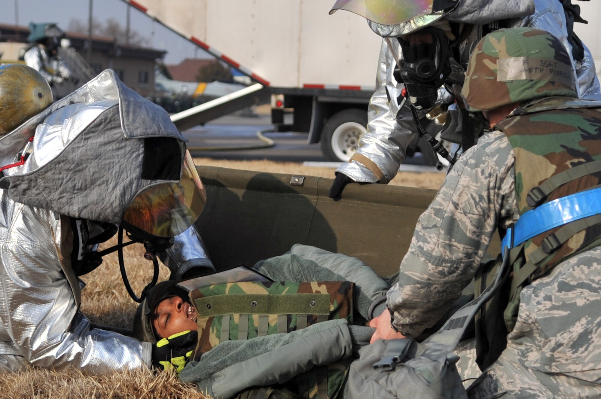 Osan Airmen work together to ensure the safety and well-being of injured personnel at Osan Air Base during operational readiness exercise Beverly Midnight 12-01, March 19, 2012. The scenario tests the readiness of Osan’s first responders as well as their abilities to work together to accomplish the mission during a heightened state of readiness. (U.S. Air Force photo/Staff Sgt. Craig R. Cisek)