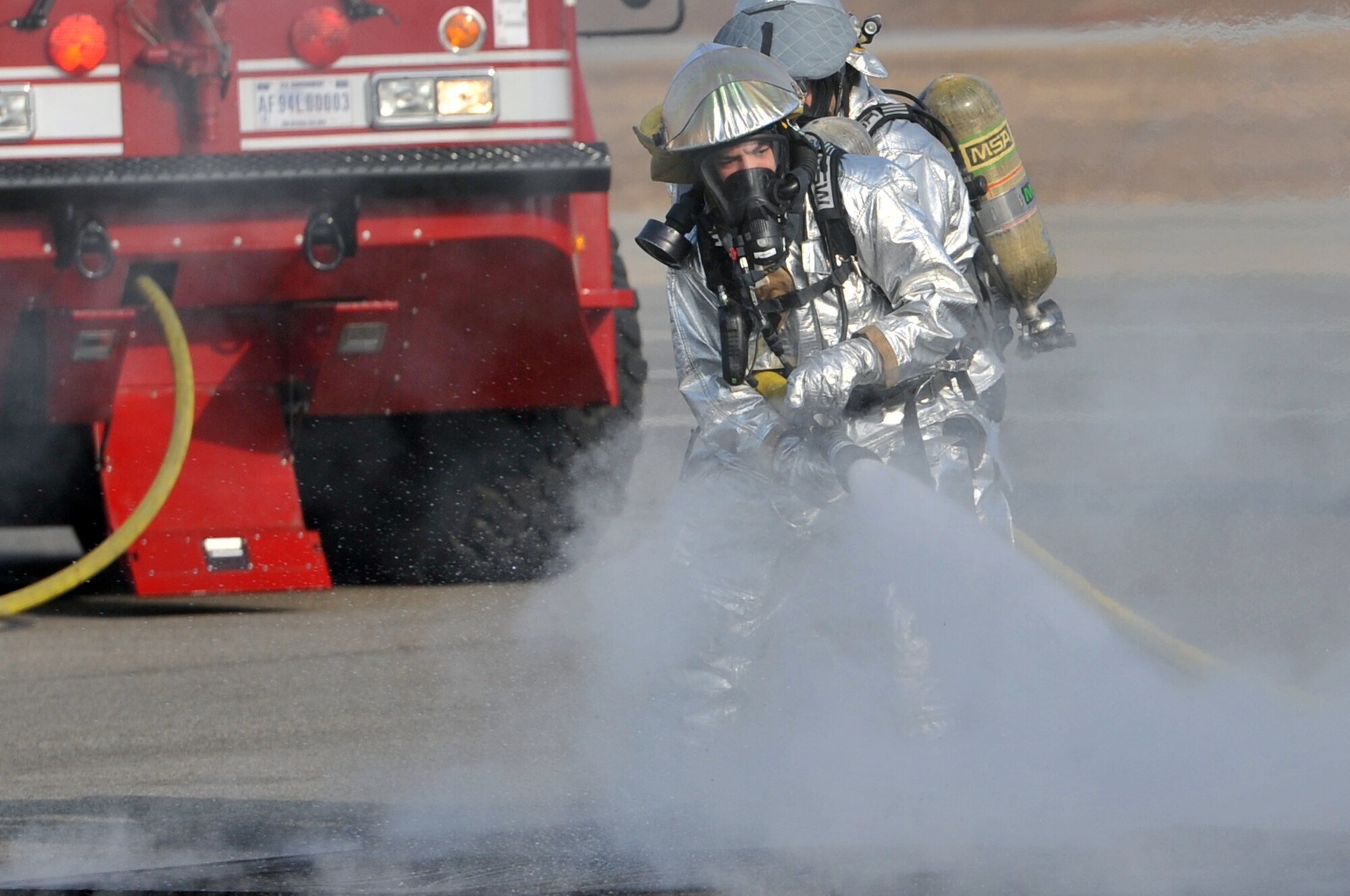 Firefighters from the 51st Civil Engineer Squadron extinguish a fire started from a simulated plane crash at Osan Air Base during operational readiness exercise Beverly Midnight 12-01, March 19, 2012. The scenarios test Team Osan’s ability to defend the base and conduct daily operations during a heightened state of readiness.  (U.S. Air Force photo/Staff Sgt. Craig R. Cisek)