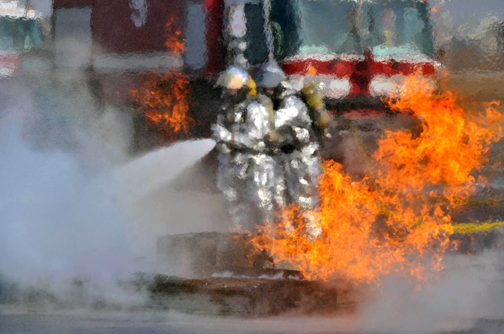 Firefighters from the 51st Civil Engineer Squadron extinguish a fire started from a simulated U.S. Air Force C-130 Hercules plane crash at Osan Air Base during operational readiness exercise Beverly Midnight 12-01, March 19, 2012. The scenarios test Team Osan’s ability to defend the base and conduct daily operations during a heightened state of readiness. (U.S. Air Force photo/Staff Sgt. Craig R. Cisek)