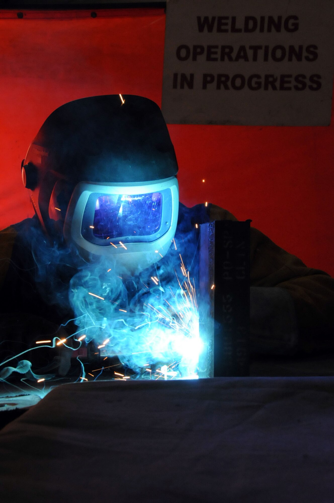U.S. Air Force Staff Sgt. Matthew Johnson, 386th Expeditionary Maintenance Squadron metals technician, demonstrates welding capabilities on a piece of steel at an undisclosed location in Southwest Asia, March 16, 2012.  Johnson is native to Mishawaka, Ind., and is deployed from the 122nd Maintenance Squadron in Ft. Wayne, Ind. (U.S. Air Force Staff Sgt. James Lieth)