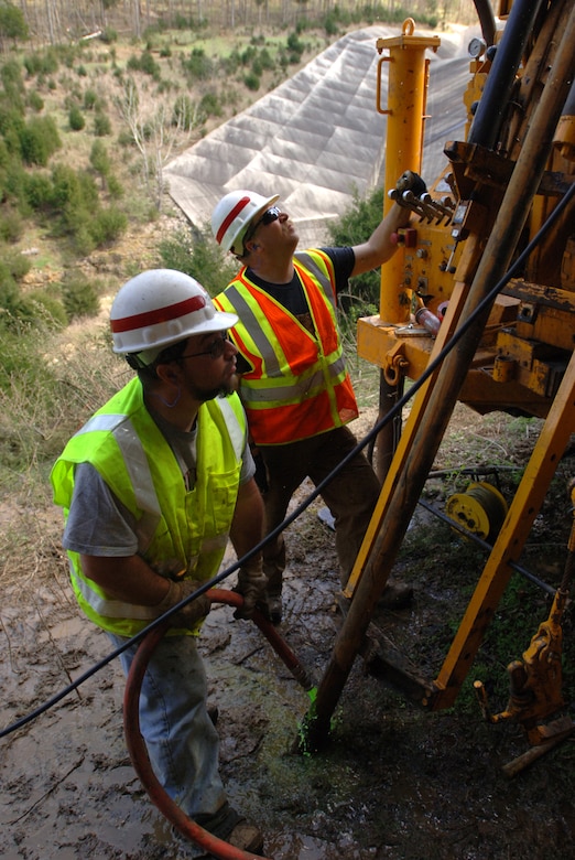 Drill Rig Operator John Blackson (right) and Helper Steve Seager, U.S. Army Corps of Engineers Baltimore District, drill a hole several hundred feet deep just downstream of the Saddle Dam to retrieve a needed core sample for the Nashville District March 14, 2012. 