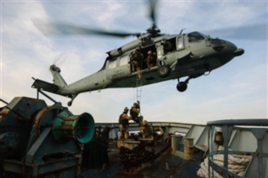 A U.S. Navy MH-60S Seahawk helicopter attached to Helicopter Sea Combat Squadron 28 conducts a shipboard extraction from an Italian Navy training vessel in the Gulf of La Spezia on March 13, 2012.  