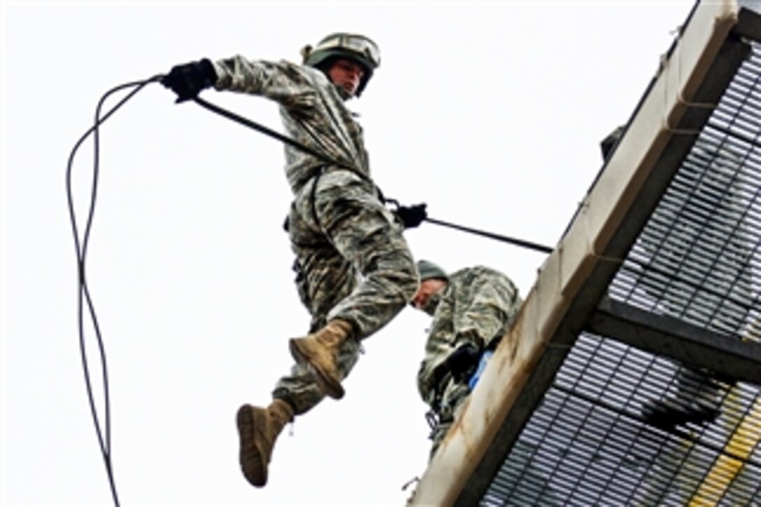 Missouri National Guardsman Cadet Andrew Cully leaps from the top of the rappel tower during part of the Guard's first Air Assault School at Camp Crowder, Mo., on March 8, 2012.  