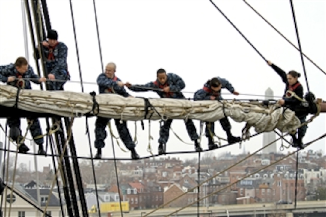 Navy sailors place the sail on the yard of the mizzenmast aboard USS Constitution in Charleston, Mass., March 14, 2012. The sailors assigned to the Constitution routinely work to improve seamanship skills to prepare for possibly sailing the ship during the bicentennial of the War of 1812. 