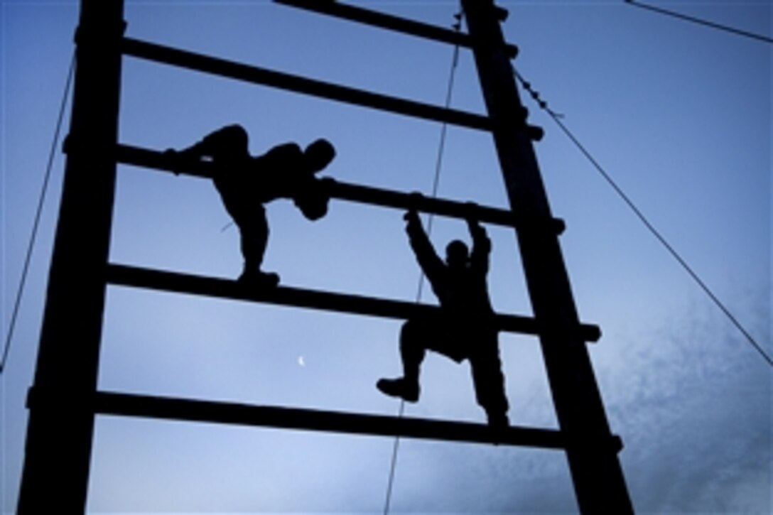 Soldiers climb an obstacle during a noncommissioned officer professional development event on Fort Bragg, N.C., March 16, 2012. The soldiers, assigned to the U.S. Army Reserve Command headquarters, negotiated the obstacles and provided teamwork when necessary to complete each station.