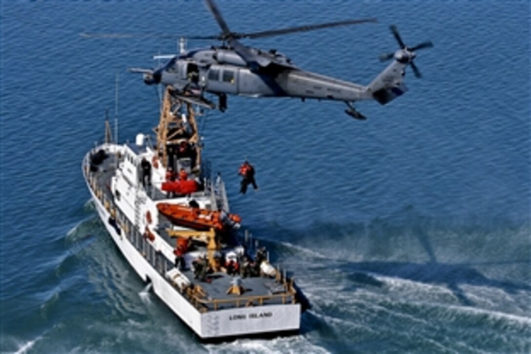 An Alaska Air National Guard HH-60G Pave Hawk helicopter performs a hoist over U.S. Coast Guard Cutter Long Island on March 14, 2012. The Alaska Air National Guard operates the Alaska Rescue Coordination Center on Elmendorf Air Force Base on the north side of Anchorage. 