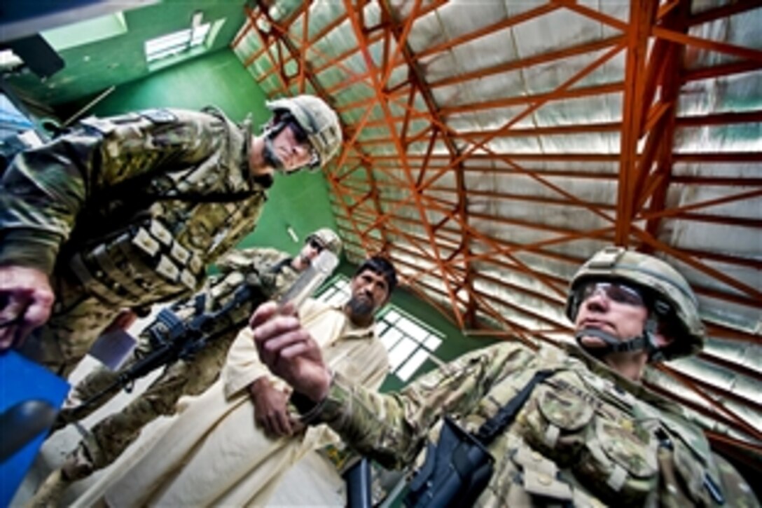 U.S. Air Force Lt. Col. Brent Beckley, right, and Capt. Gary Chura, left, inspect a local agricultural processing plant in Afghanistan's Nangarhar province, March 17, 2012. Beckley and Chura are assigned to the Nangarhar Agribusiness Development Team, which supports initiatives to ensure the sustainability of Afghan agricultural productivity.