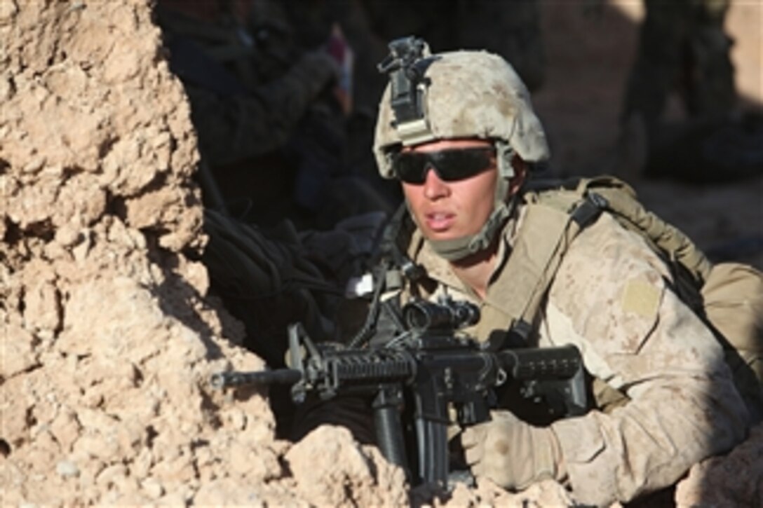 A U.S. Marine with Headquarters and Service Company, 2nd Battalion, 9th Marines, provides security during an anti-narcotics operation in Marjah, Afghanistan, on March 7, 2012.  The operation is aimed at stopping insurgent forces from transporting arms and narcotics in the Bari desert.  