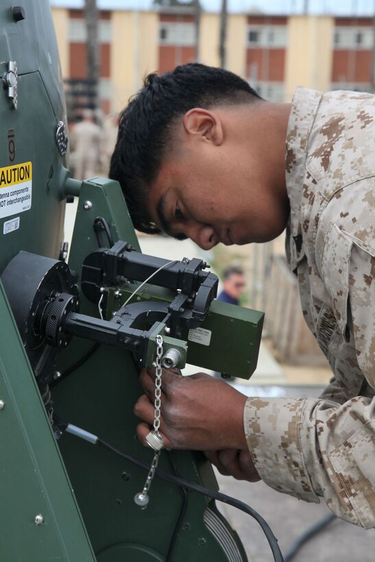 Cpl. Luis A. Gallegos, data systems technician, Combat Logistics Battalion 15, 15th Marine Expeditionary Unit, sets up a Support Wide Area Network satellite during a Communications Exercise with the entire Marine Air Ground Task Force at Camp Delmar, March 19. The five-day training exercise is meant to prepare the 15th MEU for a deployment qualification exercise in the coming future.