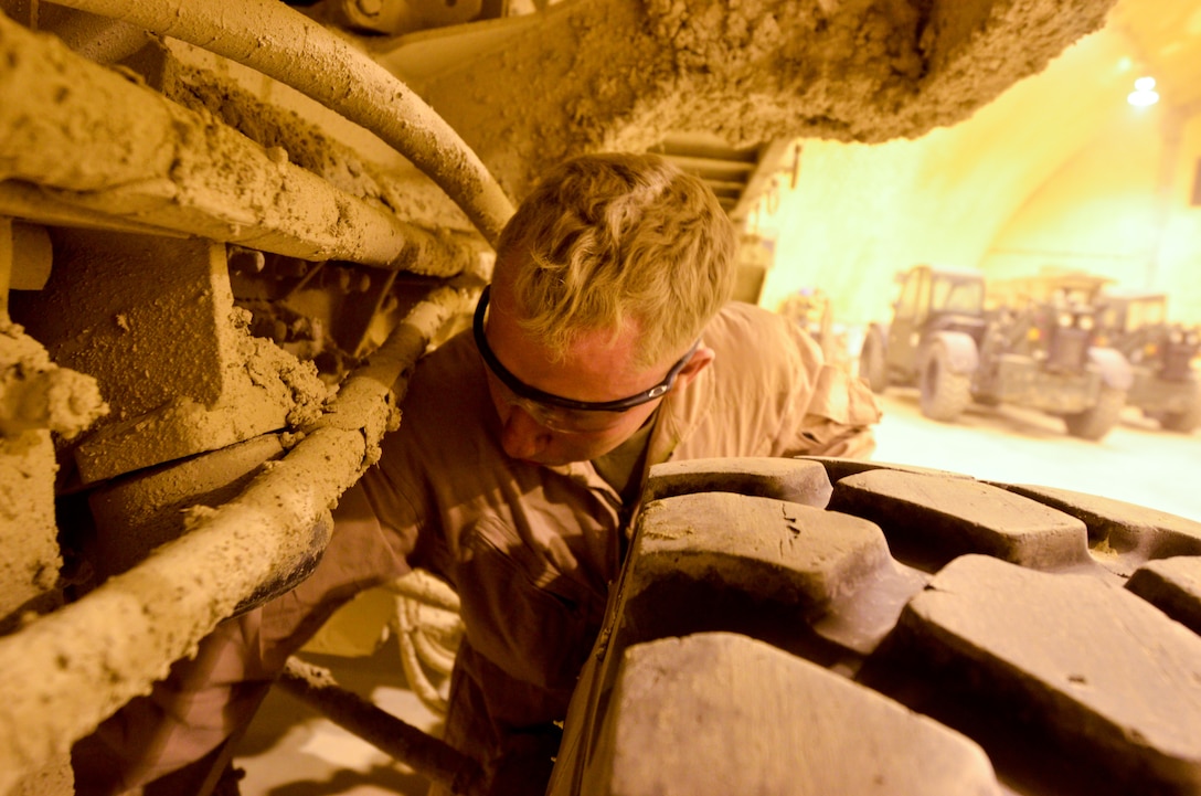 Cpl. Matthew L. Hagans, motor transportation mechanic, Support Company, Combat Logistics Battalion 4, 1st Marine Logistics Group (Forward) inspects a Logistics Vehicle System Replacement for damage in the CLB-4 maintenance bay, March 19.