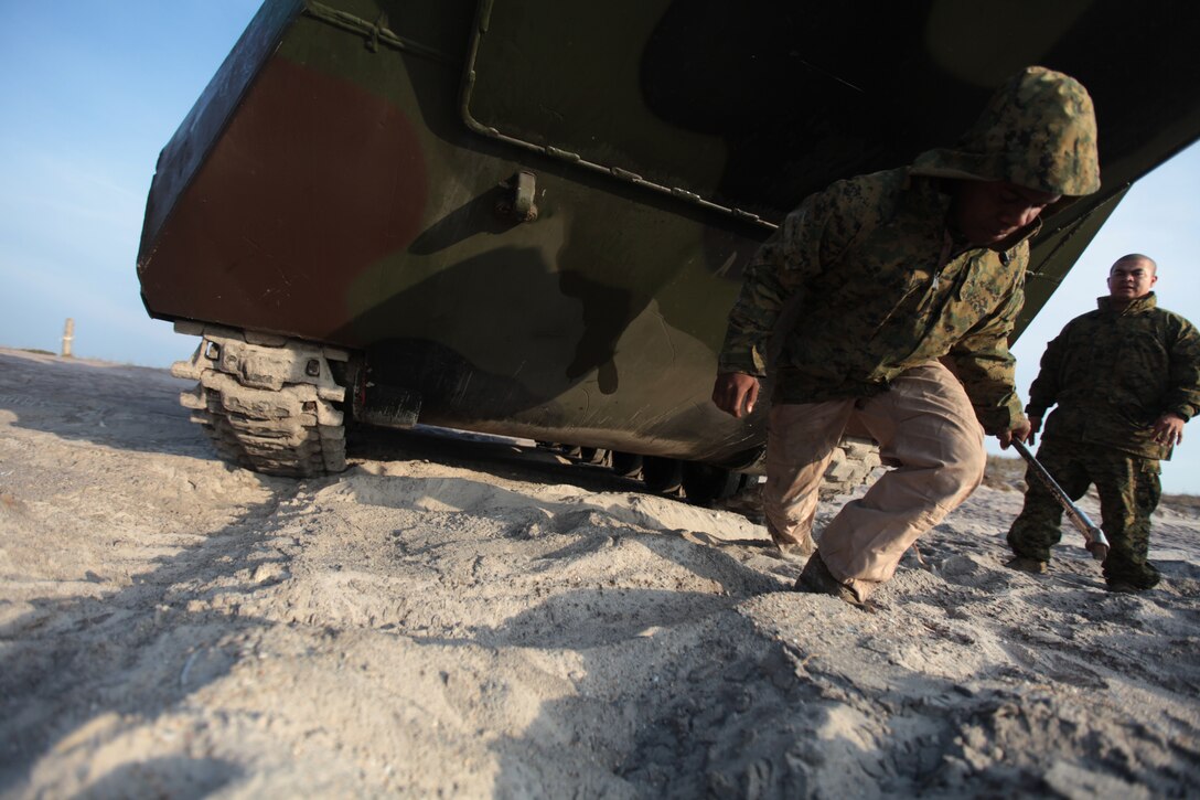 Lance Cpl. Kelvin Moore, an Amphibious Assault Vehicle crewman with 3rd Platoon, Delta Compay, 2nd Assault Amphibian Battalion, 2nd Marine Division, finishes final water integrity checks on an Amphibious Assault Vehicle before shipping out to the USS Whidbey Island March 20 at Onslow Beach aboard Marine Corps Base Camp Lejeune. Thirty-six Marines with the platoon conducted reintegration exercises from March 19 – 22 in preparation for their deployment with the Africa Partnership Station 2012 this year.