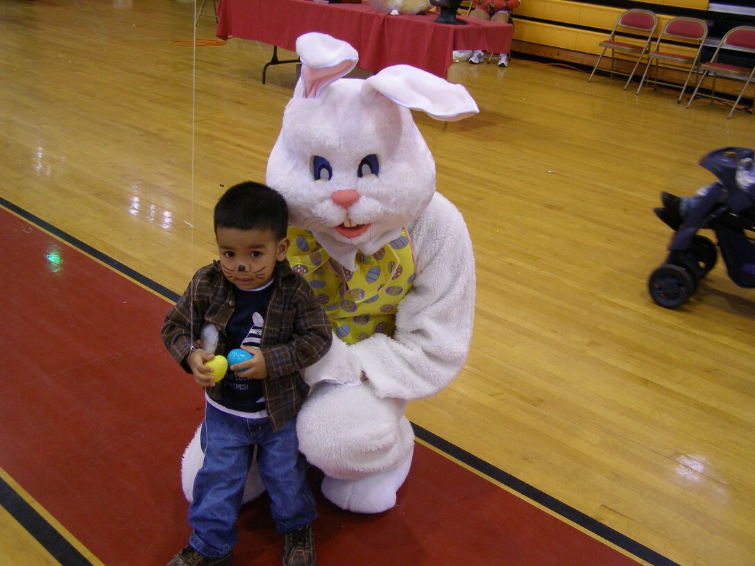 An Easter bunny poses with the son of a Marine during a previous Eggstravaganza event at a Marine Corps Base Camp Lejeune gym.  This year's event will be at William Pendleton Thompson Hill Field with arts, crafts, games and a free hotdog lunch.