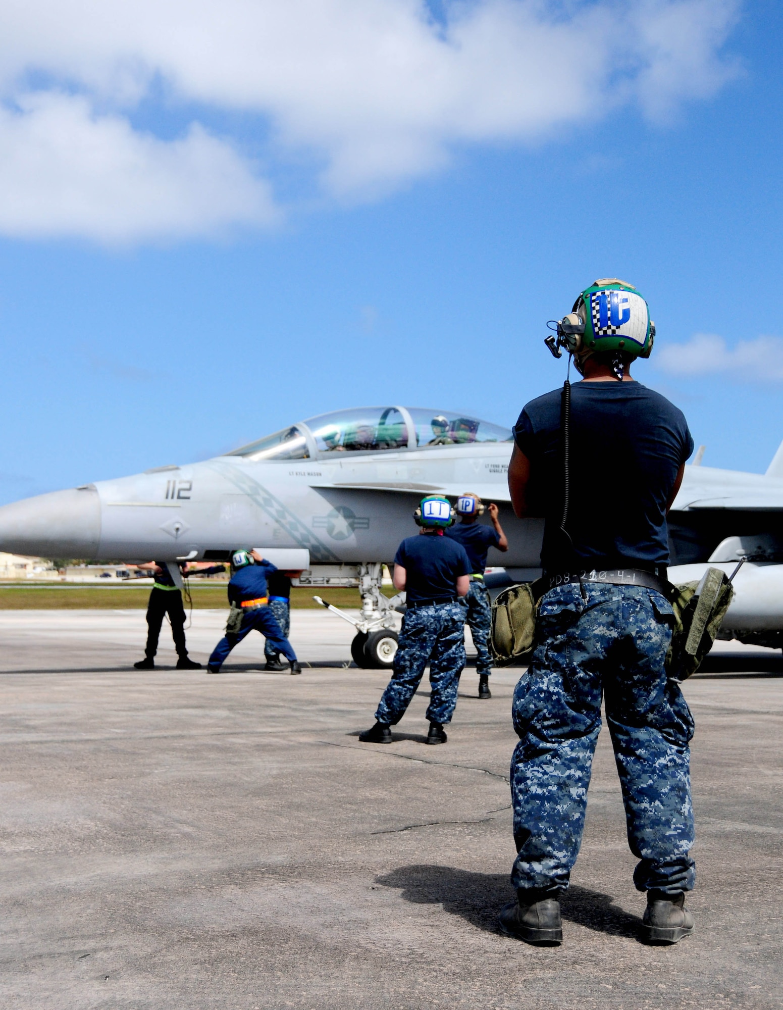 ANDERSEN AIR FORCE BASE, Guam - Naval aircraft maintainers prepare to
perform post flight maintenance on an F-18 aircraft here during the Strike
Fighter Advanced Readiness Program March 19. The Andersen is hosting the
Naval flying exercise during the month of March. (U.S. Air force photo by
Senior Airman Jeffrey Schultze)
