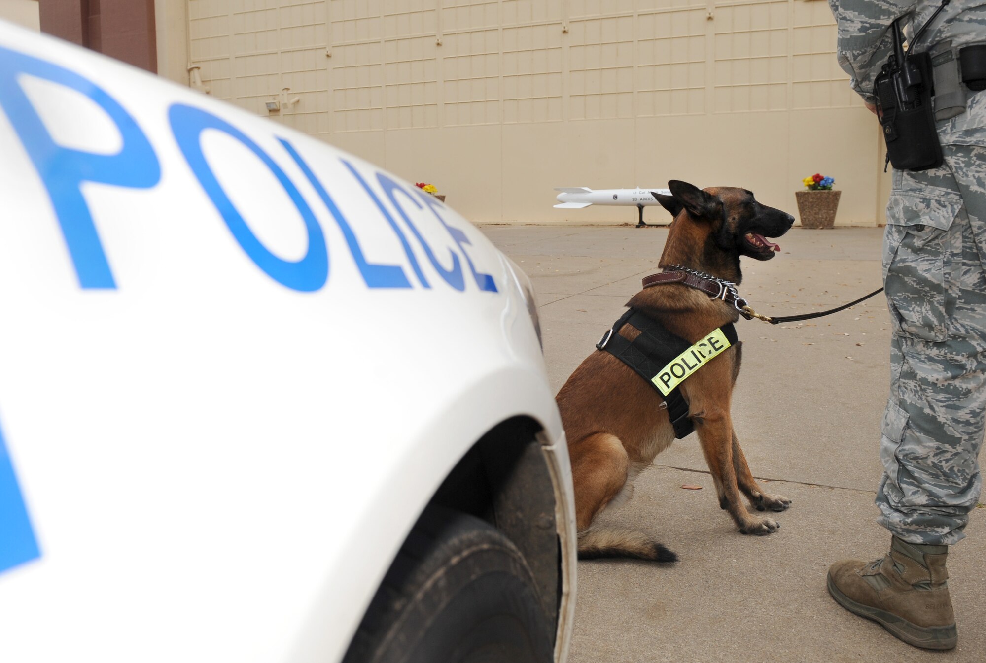 Military Working Dog Rufus and his handler, Staff Sgt. Jeffrey Lincoln, 2nd Security Forces Squadron, stand-by after responding to an alarm activation call on Barksdale Air Force Base, La., March 15. Lincoln and Rufus spend more than 60 hours together throughout the week training, performing vehicle searches, responding to calls and patrolling the base and flightline. (U.S. Air Force photo/Senior Airman Amber Ashcraft) (RELEASED)