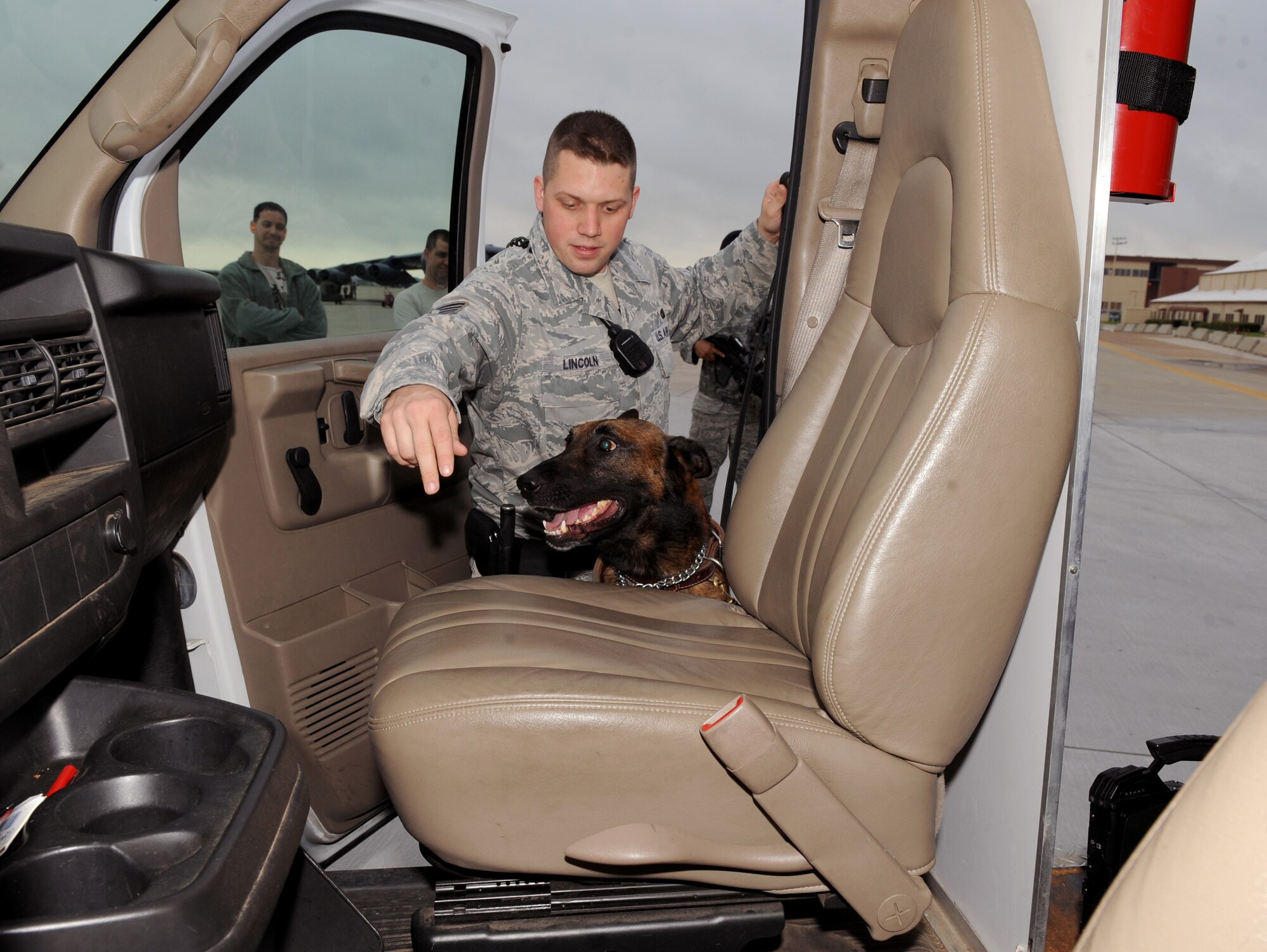 Staff Sgt. Jeffrey Lincoln, 2nd Security Forces Squadron Military Working Dog handler, and his canine Rufus, perform a vehicle inspection near the flightline on Barksdale Air Force Base, La., March 15. Lincoln and Rufus spend more than 60 hours together throughout the week training, performing vehicle searches, responding to calls and patrolling the base and flightline. (U.S. Air Force photo/Senior Airman Amber Ashcraft) (RELEASED)