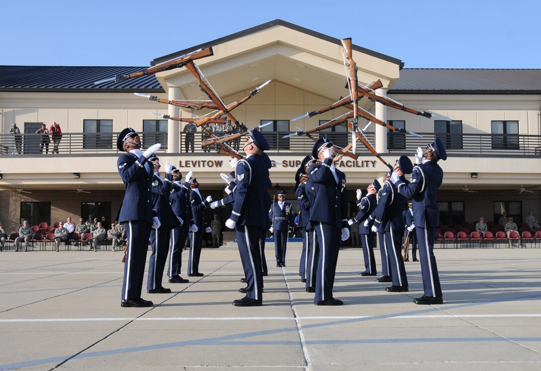 The U.S. Air Force Honor Guard Drill Team executes the newly unveiled 16-man drill performance March 6 on Keesler Air Force Base, Miss. Drill Team members attended a month long training camp in which they revamped drills, giving them a new edge for upcoming 2012 performances. Airmen from Keesler were among the first to witness the newly choreographed routine. (U.S. Air Force by Kemberly Groue) 