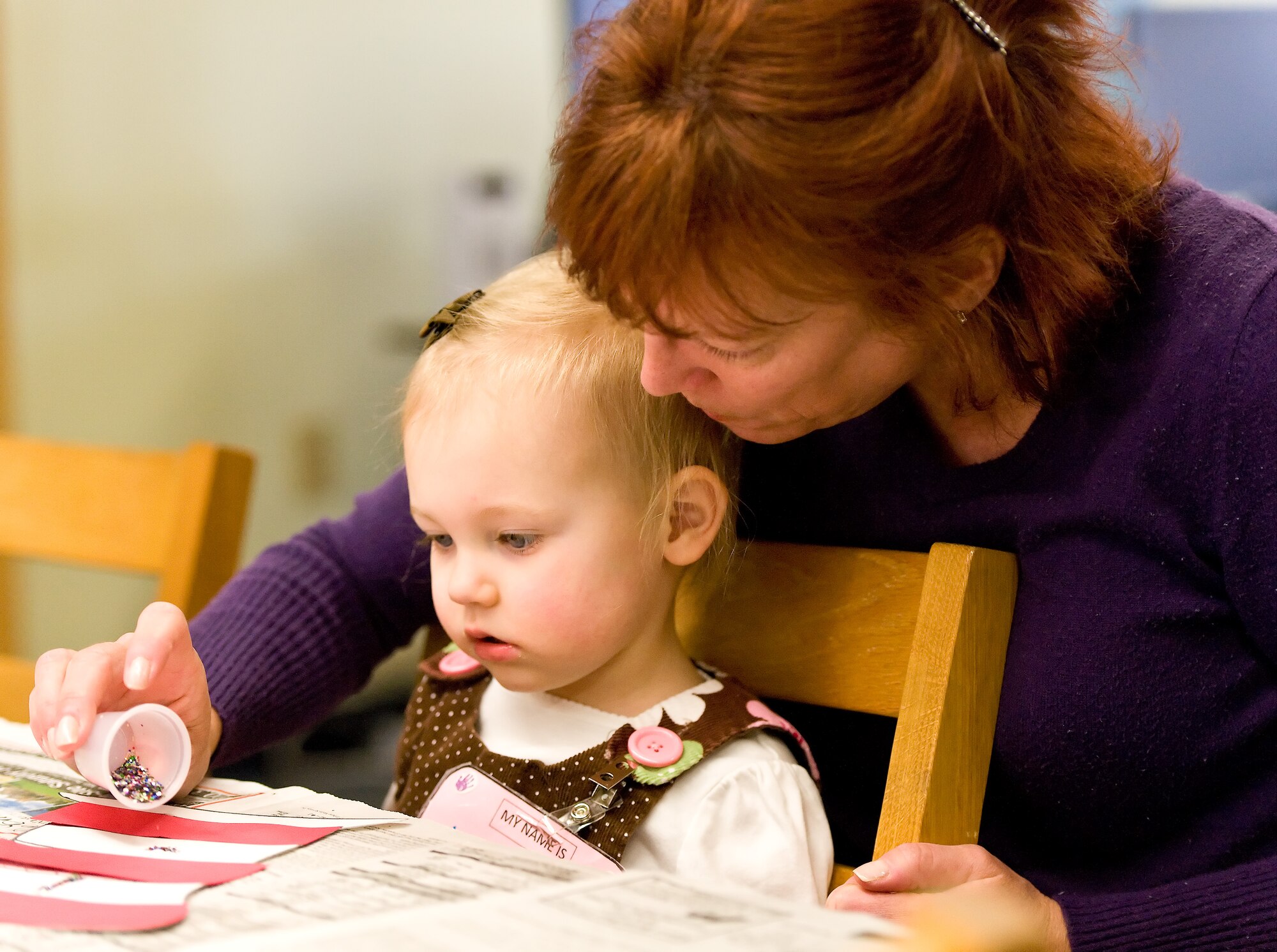 Loretta Wells, 2, and Christine Wells, her grandmother, work on an art project during story time March 7, 2012, at the Dover Air Force Base, Del., Library. Wanda Lingham, circulation technician with the 436th Force Support Squadron Base Library, read two books to the children: “The Best Nest,” by P.D. Eastman and “Marvin K. Mooney Will You Please Go Now,” by Dr. Seuss. After reading both books, Lingham provided the children with materials for an art project. Story time is held every Wednesday at 10:30 a.m. and is open to all dependent children of military members. (U.S. Air Force photo by Roland Balik)