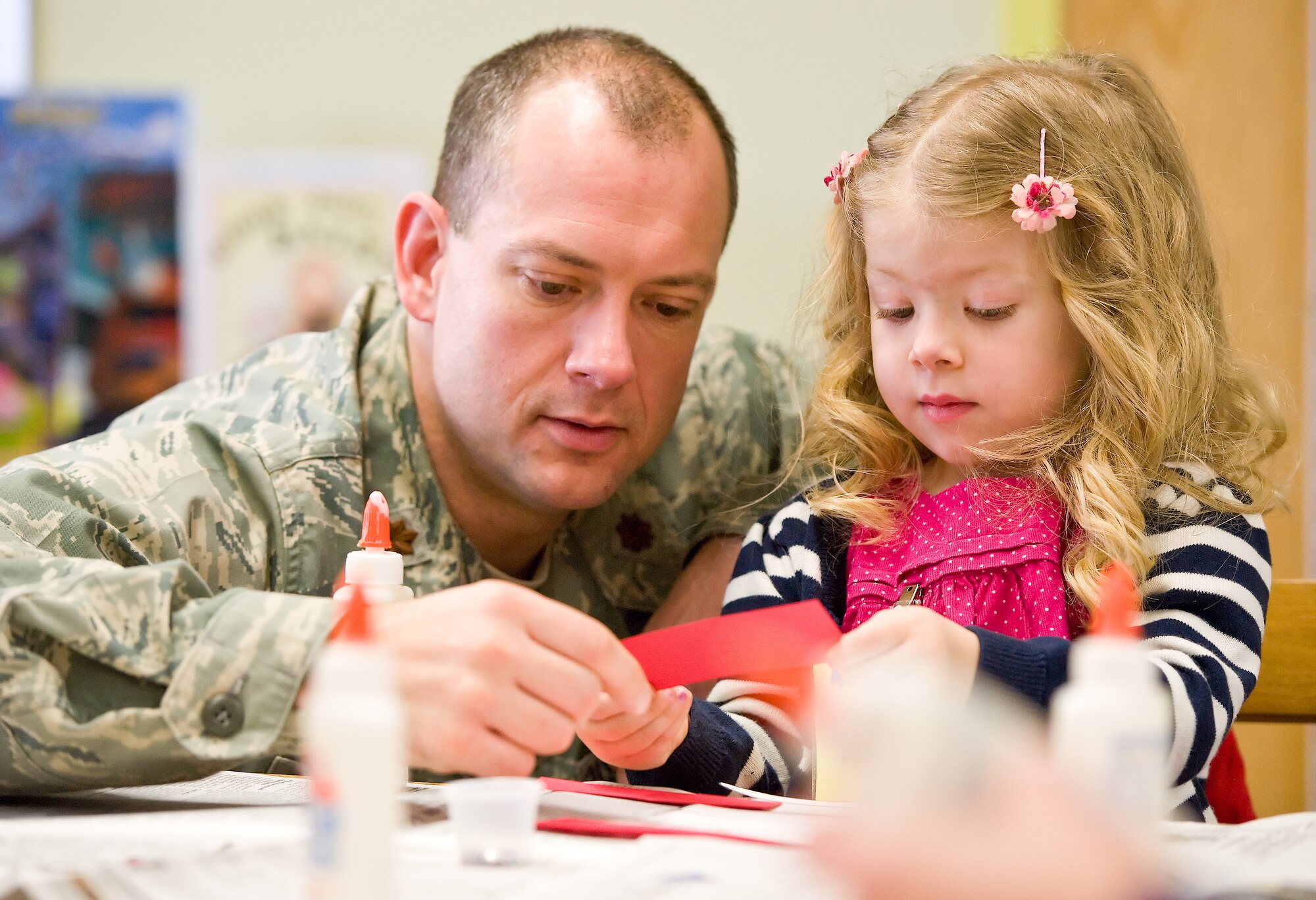 Viola Montgomery, 4, daughter of Maj. James Montgomery work together on an art project during story time March 7, 2012, at the Dover Air Force Base, Del., Library. Wanda Lingham, circulation technician with the 436th Force Support Squadron Base Library, read two books to the children: “The Best Nest,” by P.D. Eastman and “Marvin K. Mooney Will You Please Go Now,” by Dr. Seuss. After reading both books, Lingham provided the children with materials for an art project. (U.S. Air Force photo by Roland Balik)