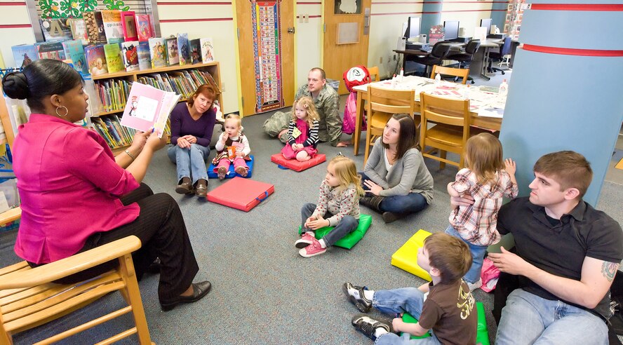 Loretta Wells, 2, and Christine Wells, her grandmother, listen to Wanda Lingham, circulation technician with the 436th Force Support Squadron Base Library, read during story time March 7, 2012, at the Dover Air Force Base, Del., Library. Team Dover members listened to Lingham read two books: “The Best Nest,” by P.D. Eastman and “Marvin K. Mooney Will You Please Go Now,” by Dr. Seuss. After reading both books, Lingham provided the children with materials for an art project. Story time is held every Wednesday at 10:30 a.m., and is open to all dependent children of military members. (U.S. Air Force photo by Roland Balik)