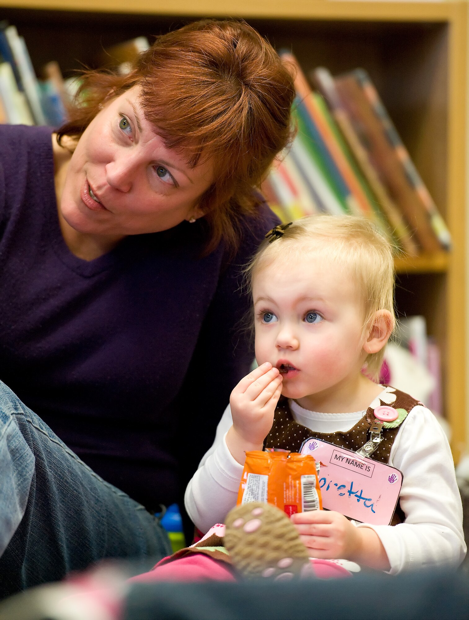 Loretta Wells, 2, and Christine Wells, her grandmother, listen to Wanda Lingham, circulation technician with the 436th Force Support Squadron Base Library, read during story time March 7, 2012, at the Dover Air Force Base, Del., Library. Team Dover members listened to Lingham read two books: “The Best Nest,” by P.D. Eastman and “Marvin K. Mooney Will You Please Go Now,” by Dr. Seuss. After reading both books, Lingham provided the children with materials for an art project. Story time is held every Wednesday at 10:30 a.m., and is open to all dependent children of military members. (U.S. Air Force photo by Roland Balik)