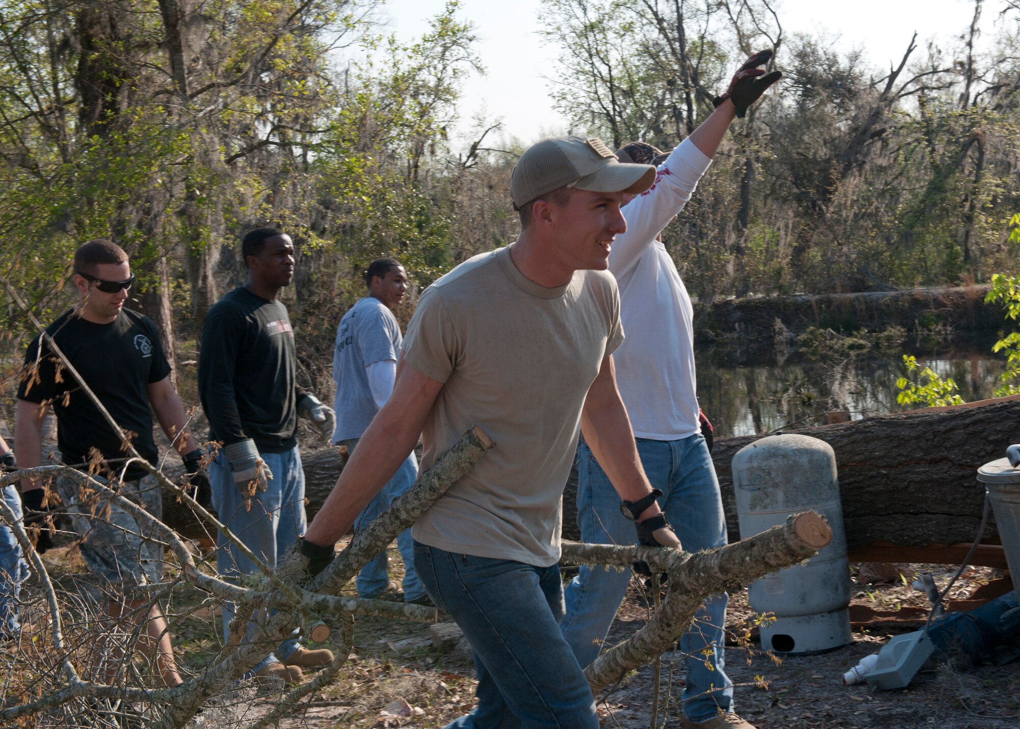 U.S. Air Force Airman 1st Class Fedor Potanin, 823d Base Defense Squadron, helps clean up debris at a house in Lakeland, Ga., March 17, 2012. The house was hit by a tornado that registered up to 140 mph two weeks prior. Volunteers from Moody Air Force Base, Ga. and the local community responded to the affected families and citizens by providing support with clean up efforts. (U.S. Air Force photo by Senior Airman Eileen Meier/Released)