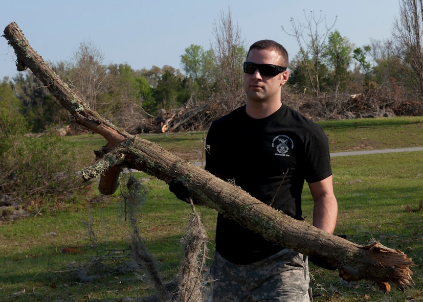 U.S. Air Force Staff Sgt. Chris Schultz, 820th Combat Operations Squadron, helps clear debris at a house that received damage from a tornado that registered up to 140 mph in Lakeland, Ga., March 17, 2012. Members of the local community teamed up with volunteers from Moody Air Force Base, Ga., to assist the affected citizens in cleaning up and providing support where needed. (U.S. Air Force photo by Senior Airman Eileen Meier/Released)