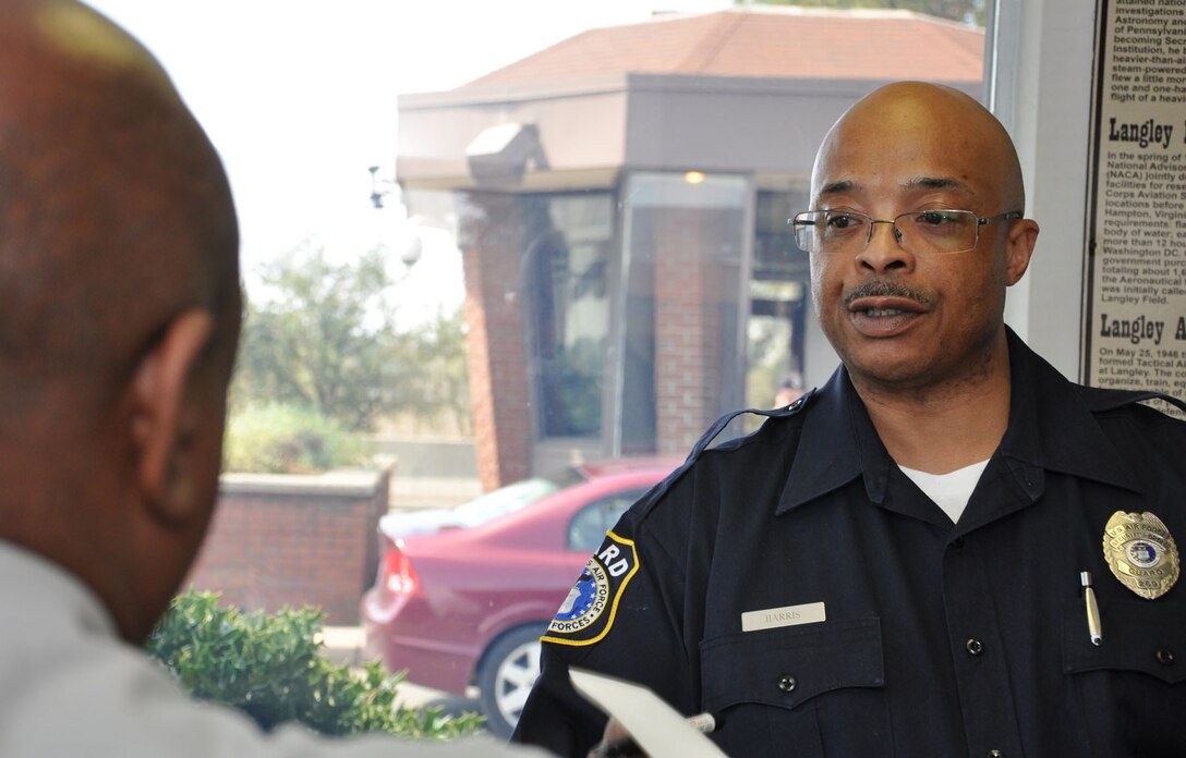 Officer Donald Harris, a Department of the Air Force guard with the 633rd Security Forces Squadron, finalizes paperwork with a contractor for access to Langley Air Force Base, Va., Mar. 20, 2012. Langley AFB and Fort Eustis will soon be switching to the Defense Biometric Identification System to improve security and civilian access to the base when necessary. (U.S. Air Force photo by Airman 1st Class Austin Harvill/Released)
