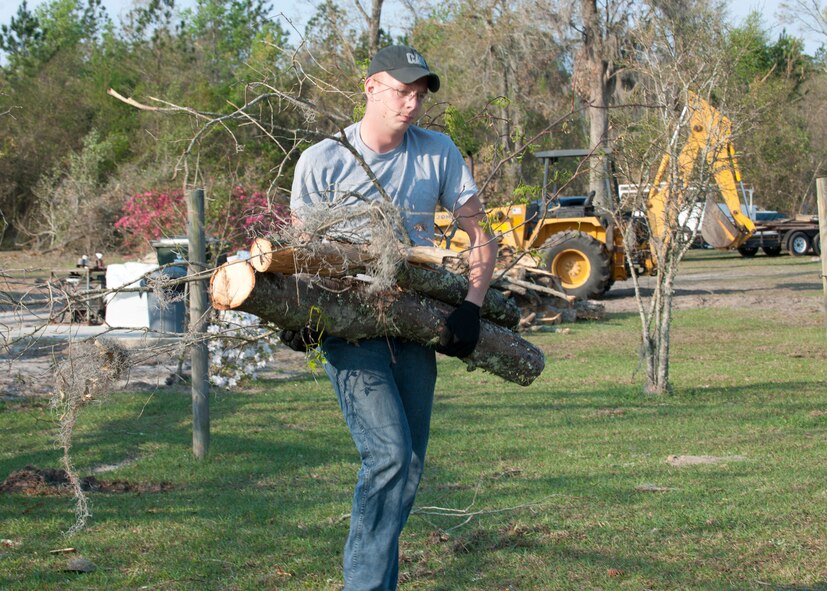 U.S. Air Force Airman 1st Class Corey Downing , 723d Aircraft Maintenance Squadron, volunteers at a home that suffered significant damage from a tornado that registered up to 140 mph  in Lakeland, Ga., March 17, 2012.  The tornado tore through Lowndes and Lanier counties March 3. Airmen from Moody Air Force Base and members of the local community have been offering helping hands by moving fallen trees and telephone poles from streets, cleaning up scattered debris and providing food and shelter to the affected citizens. (U.S. Air Force photo by Senior Airman Eileen Meier/Released)