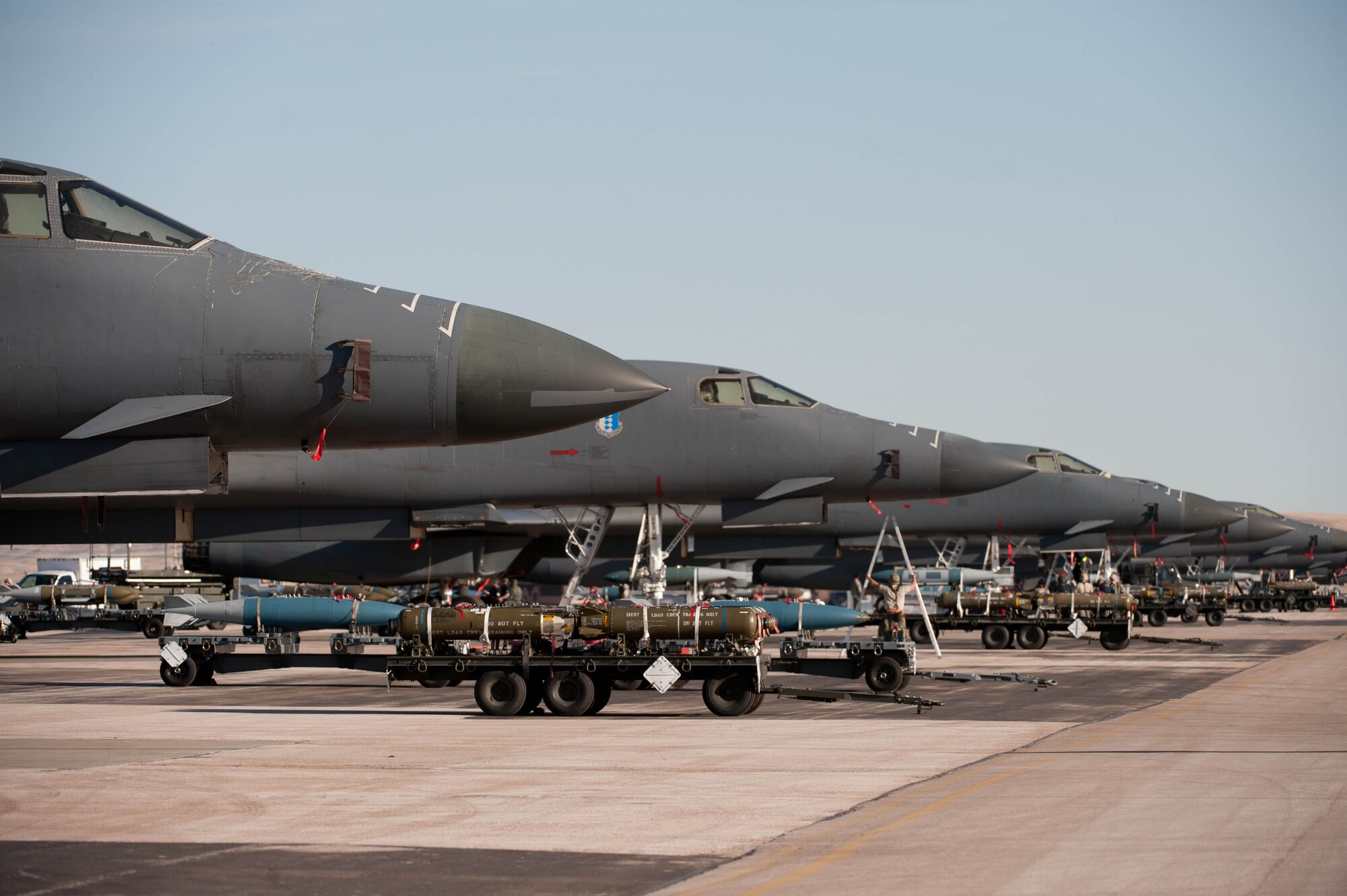 A variety of munitions are lined up on the flightline near parked B-1 bombers during an Operational Readiness Exercise at Ellsworth Air Force Base, S.D., March 15, 2012. The ORE covered a wide range of operations and was designed to test Airmens ability to deploy personnel, aircraft and equipment. (U.S. Air Force photo by Airman 1st Class Zachary Hada/Released)
