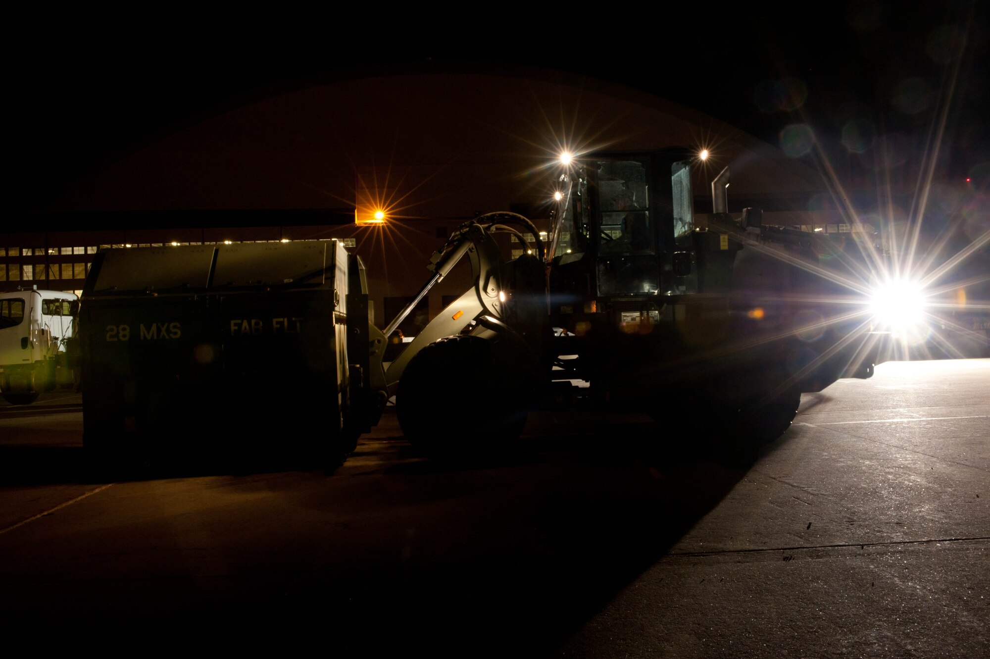 Cargo and equipment are transported by heavy machinery through a marshaling yard by Airmen from multiple squadrons on cargo management duty during an Operational Readiness Exercise at Ellsworth Air Force Base, S.D., March 14, 2012. Part of the exercise was designed to test the base’s ability to move equipment effectively at a simulated deployed location. (U.S. Air Force photo by Airman 1st Class Zachary Hada/Released)