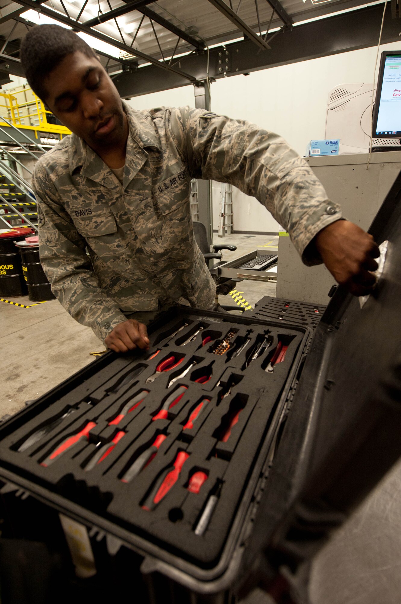 Senior Airman Sandon Davis, 28th Aircraft Maintenance Squadron composite tool kit specialist, processes equipment during an Operational Readiness Exercise at Ellsworth Air Force Base, S.D., March 14, 2012. Davis and other CTK specialists manage and stock replacement tools as 28th AMXS maintainers check them in and out on. (U.S. Air Force photo by Airman 1st Class Zachary Hada/Released)