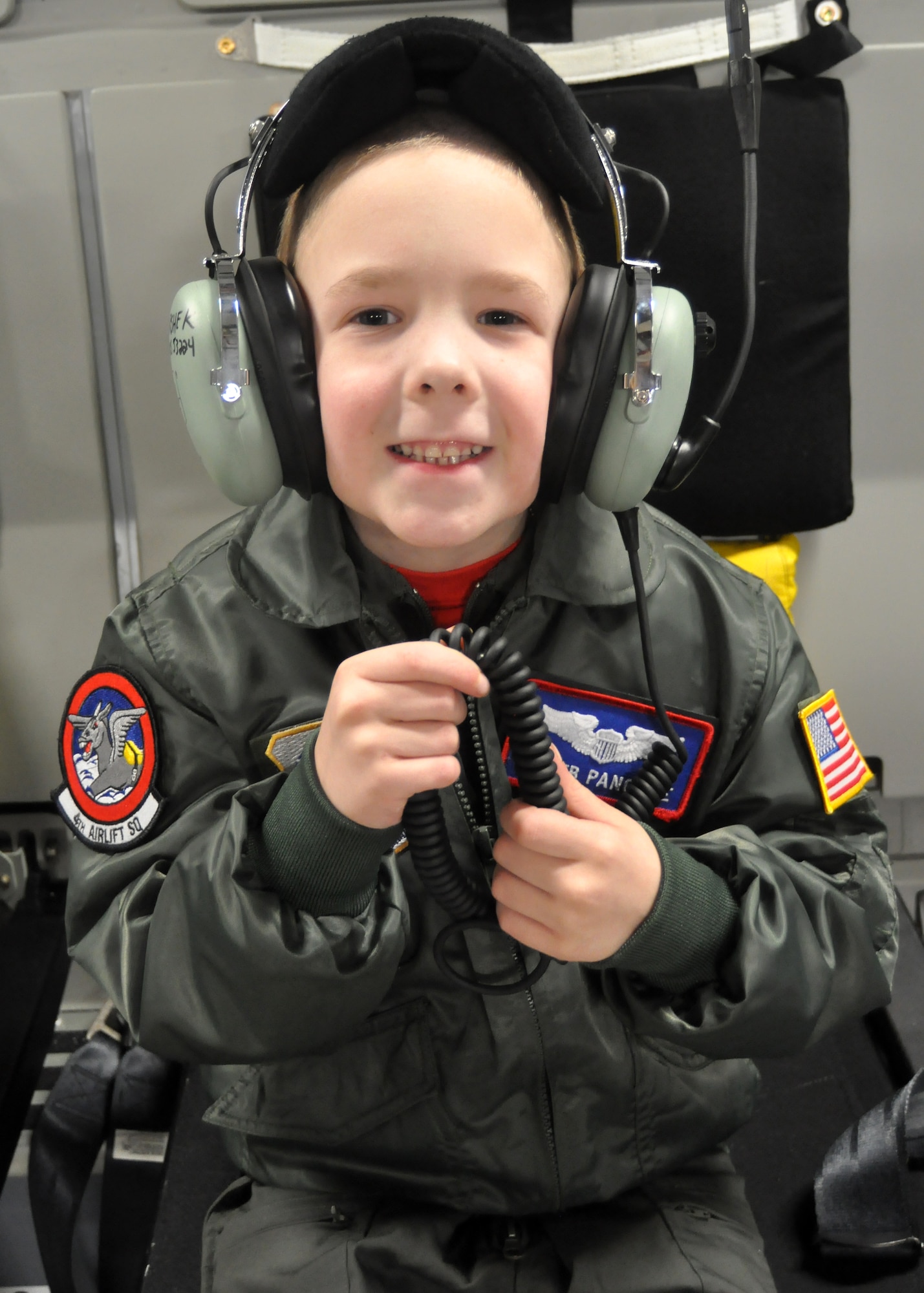 Caleb Pancake wears an aircrew headset while on a tour of a C-17 Globemaster III as part of the Pilot for a Day program March 16, 2012, at Joint Base Lewis-McChord, Wash. (U.S. Air Force photo/Airman 1st Class Leah Young)