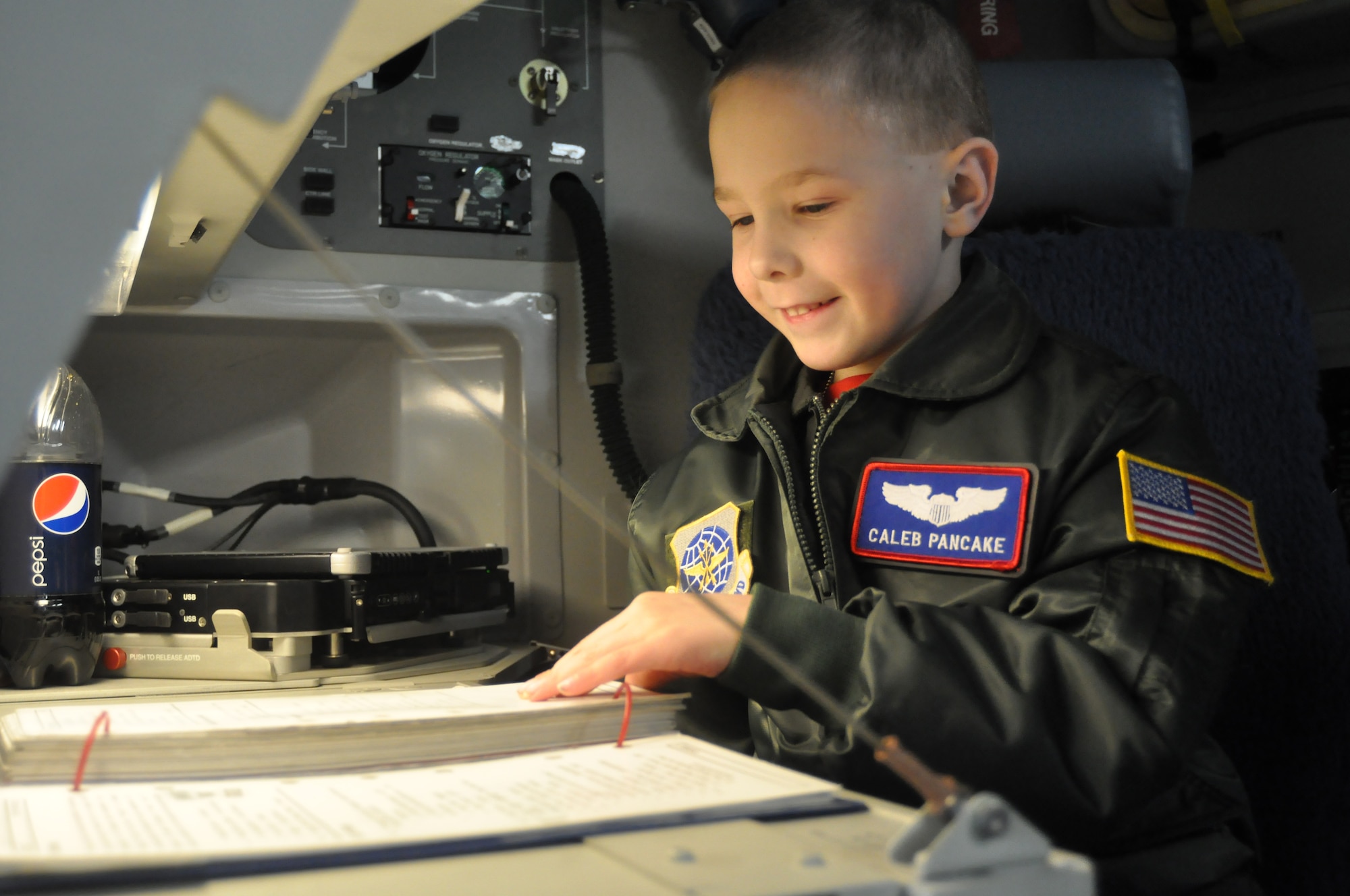 Caleb Pancake reads an aircrew checklist while on a tour of a C-17 Globemaster III as part of the Pilot for a Day program March 16, 2012, at Joint Base Lewis-McChord, Wash. (U.S. Air Force photo/Airman 1st Class Leah Young)