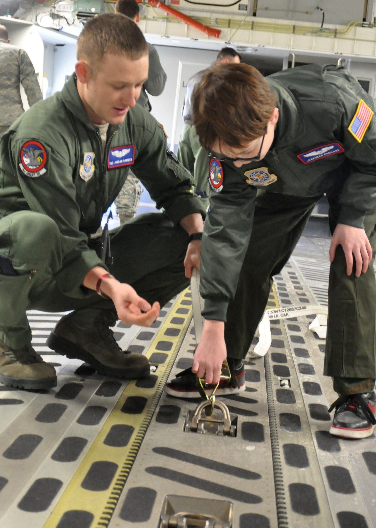 Senior Airman Jordan Rayman, 4th Airlift Squadron loadmaster, teaches Jeremiah Pancake different functions of a C-17 Globemaster III and its equipment as part of the Pilot for a Day program March 16, 2012, at Joint Base Lewis-McChord, Wash. (U.S. Air Force photo/Airman 1st Class Leah Young)