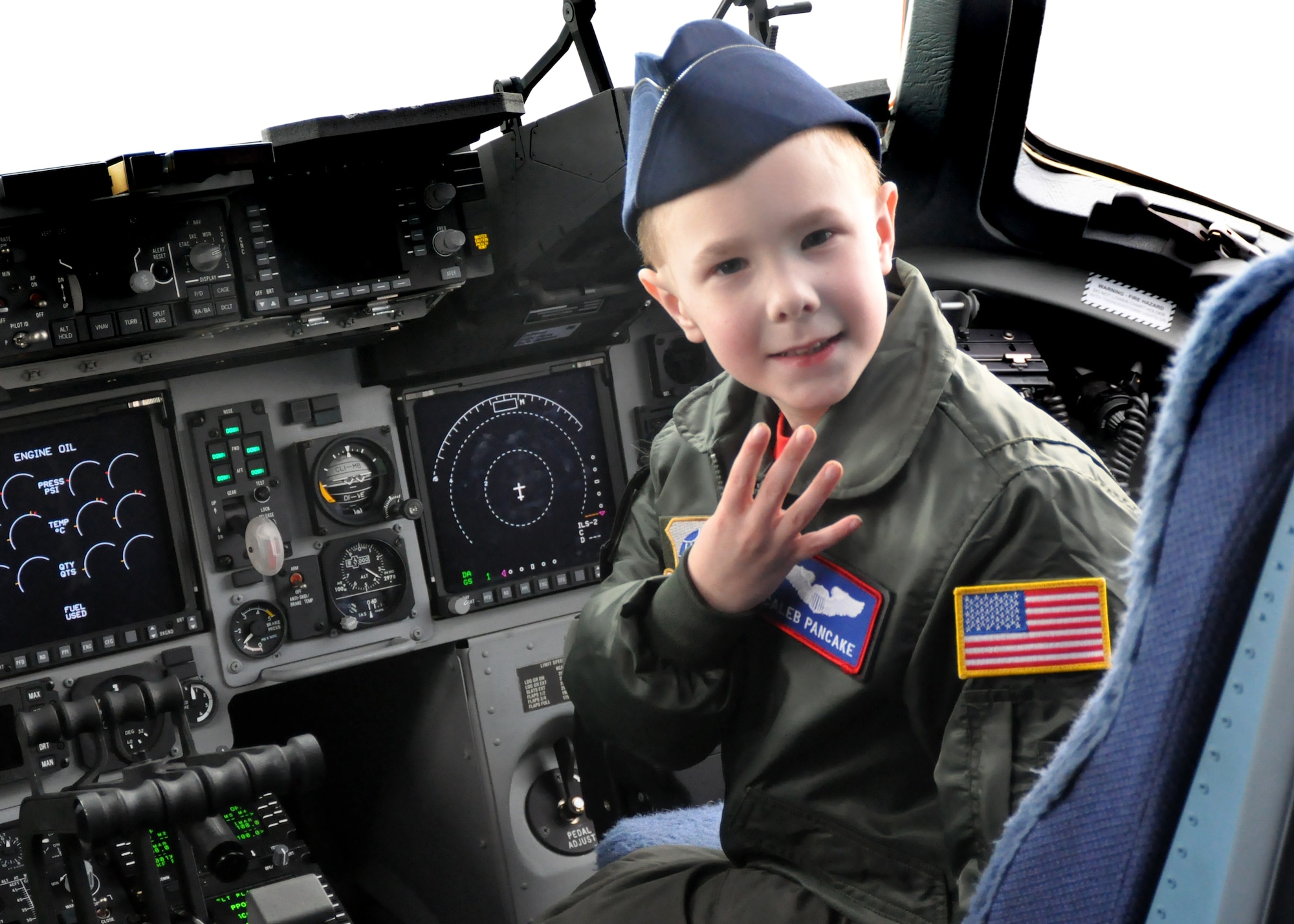 Caleb Pancake sits in the cockpit of a C-17 Globemaster III as part of the Pilot for a Day program March 16, 2012, at Joint Base Lewis-McChord, Wash. Pilot for a Day is an Air Force program that enables challenged youth a chance to visit a military installation, becoming part of the team in the process. (U.S. Air Force photo/Airman 1st Class Leah Young)