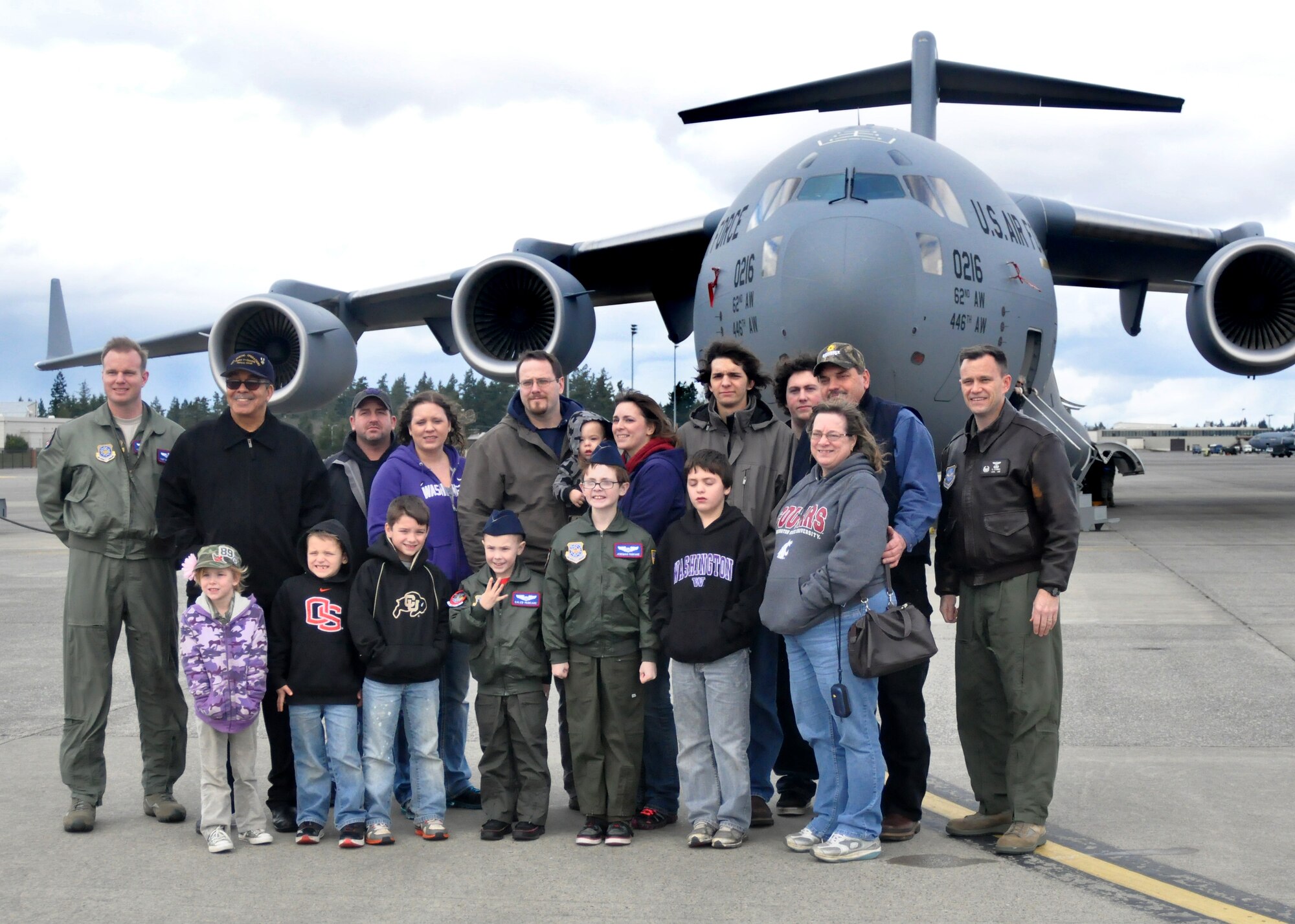 Caleb and Jeremiah Pancake, along with family members, stand in front of a C-17 Globemaster III with members of the 4th Airlift Squadron as part of the Pilot for a Day program March 16, 2012, at Joint Base Lewis-McChord, Wash. The guests had an opportunity to tour the JBLM fire station, experience an explosive ordnance disposal demonstration and get a personal tour of a C-17 Globemaster III.  (U.S. Air Force photo/Airman 1st Class Leah Young)