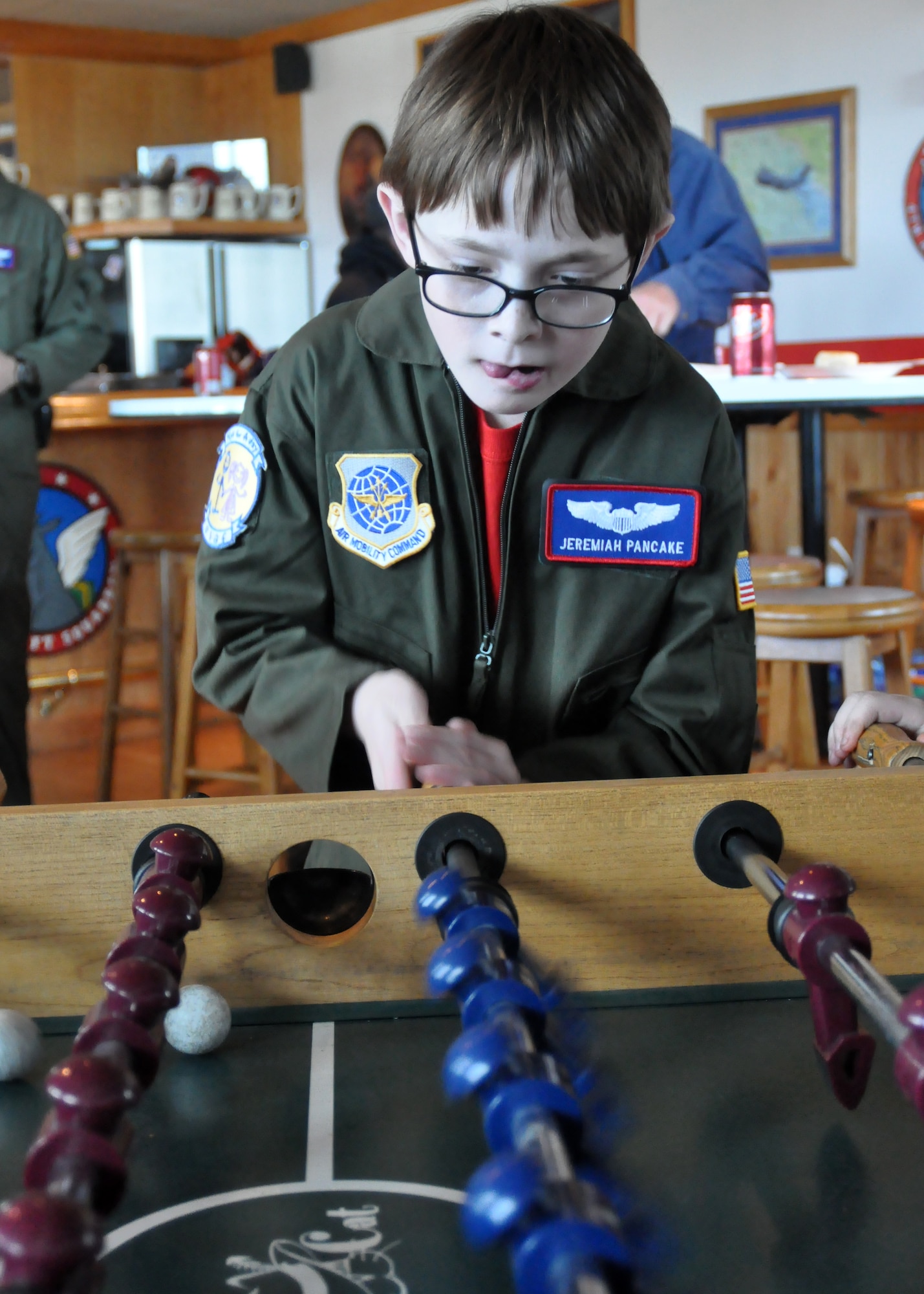 Jeremiah Pancake plays foosball at the 4th Airlift Squadron as part of the Pilot for a Day program March 16, 2012, at Joint Base Lewis-McChord, Wash. (U.S. Air Force photo/Airman 1st Class Leah Young)